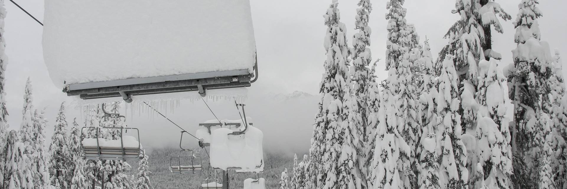 Very deep snow stacked on a chairlift at The Summit
