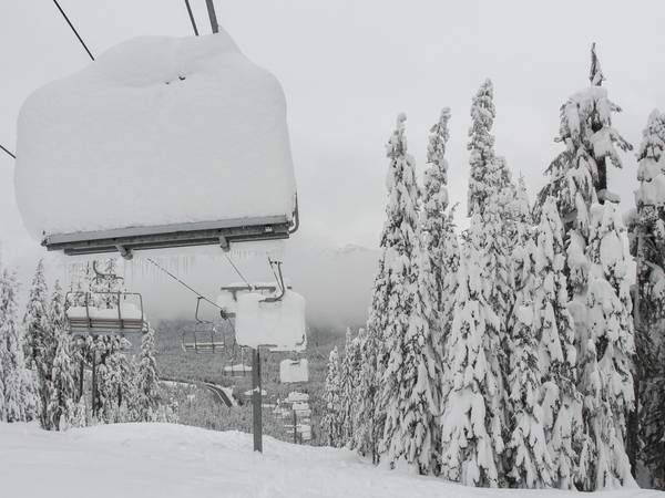 Very deep snow stacked on a chairlift at The Summit