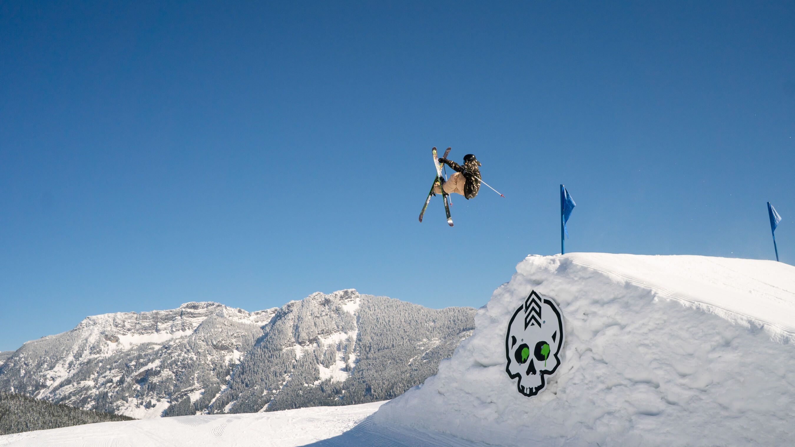 skier big jump doing tip grab