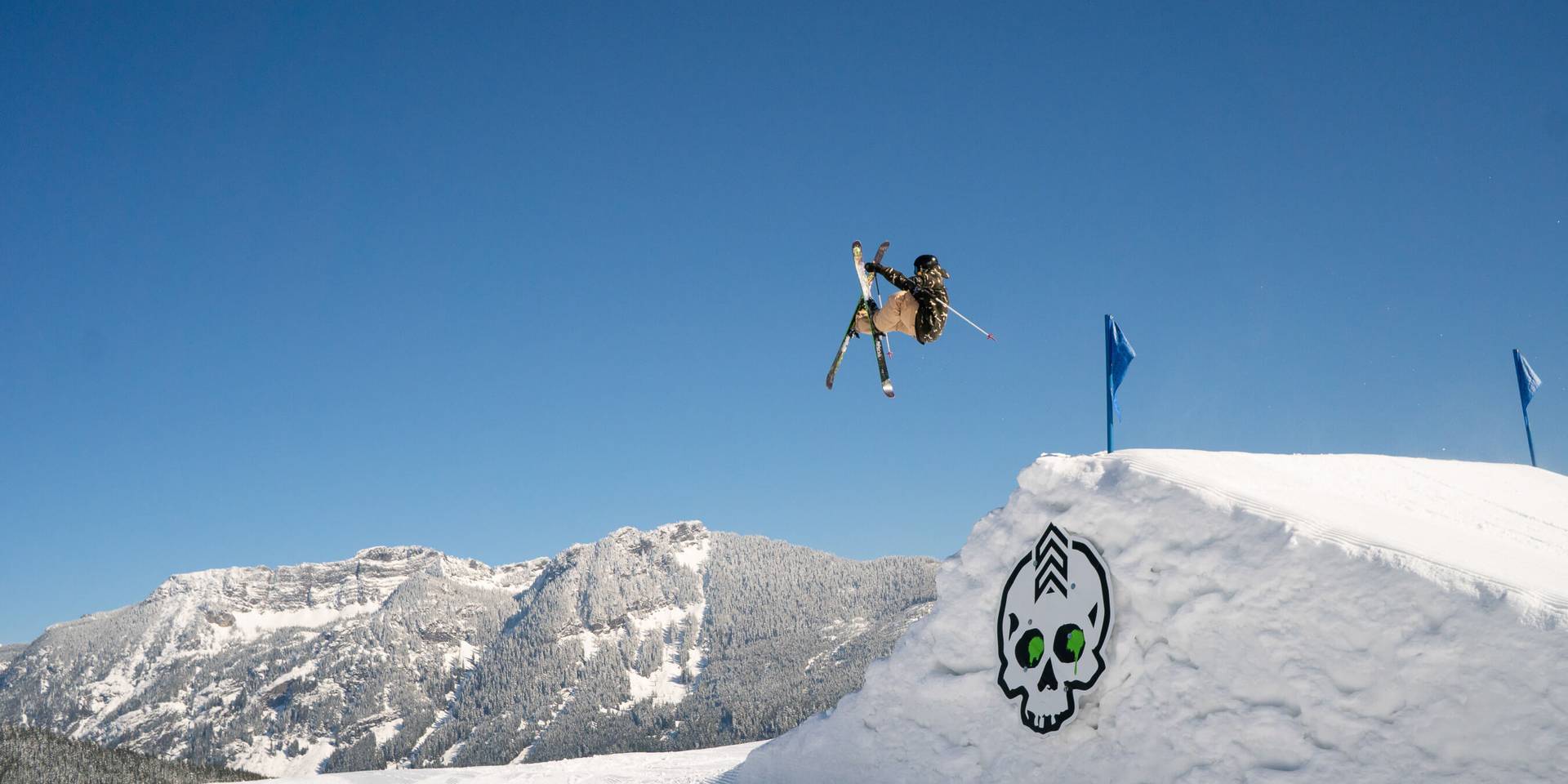 skier big jump doing tip grab