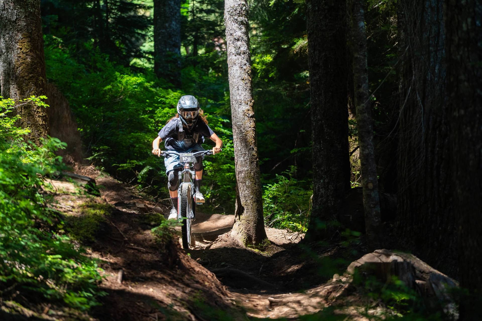 speed series racer riding a bike through trees