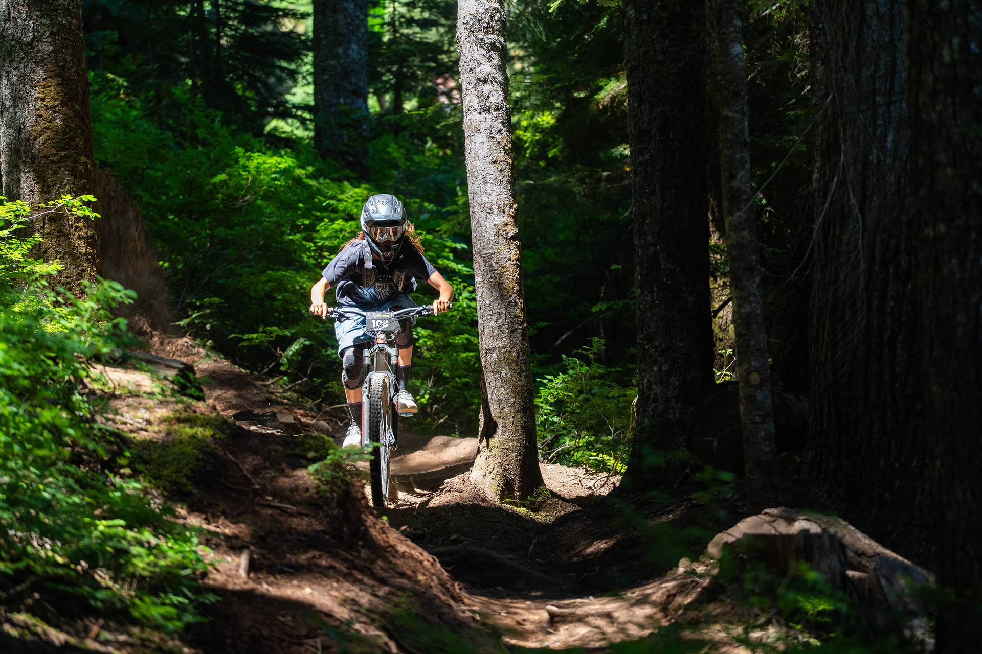 speed series racer riding a bike through trees