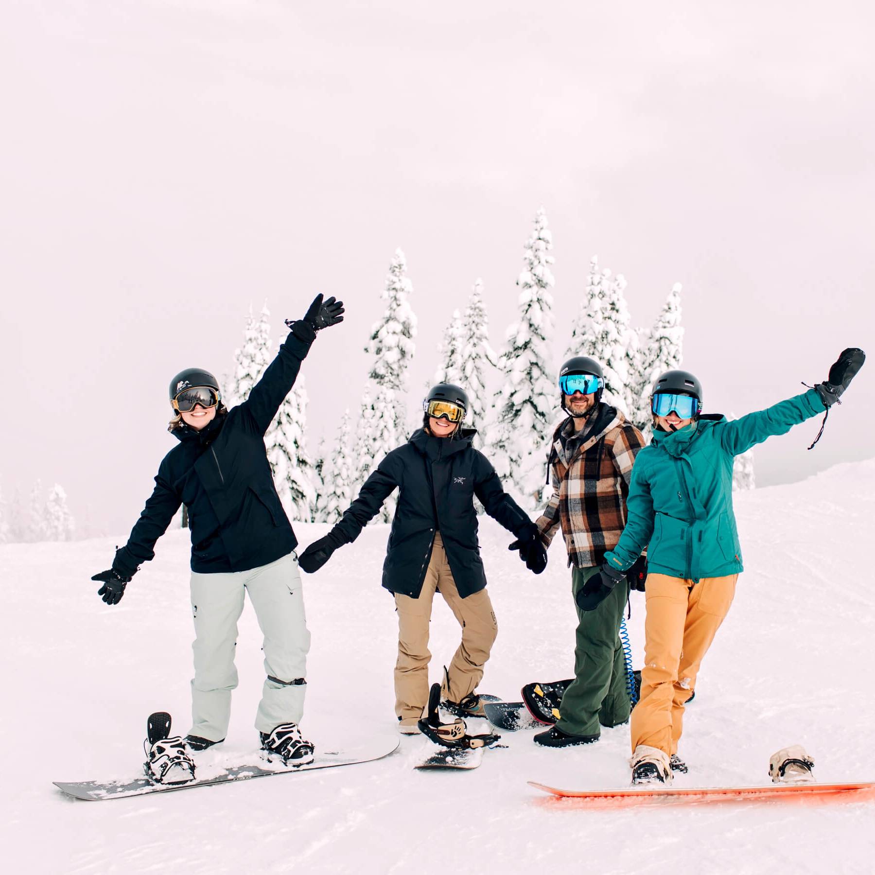 group of snowboarders posing for the camera
