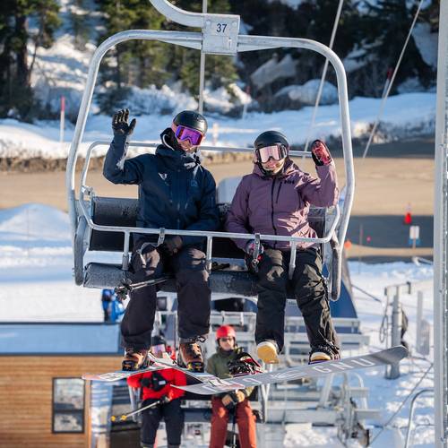 stoked snowboarders with snowy trees