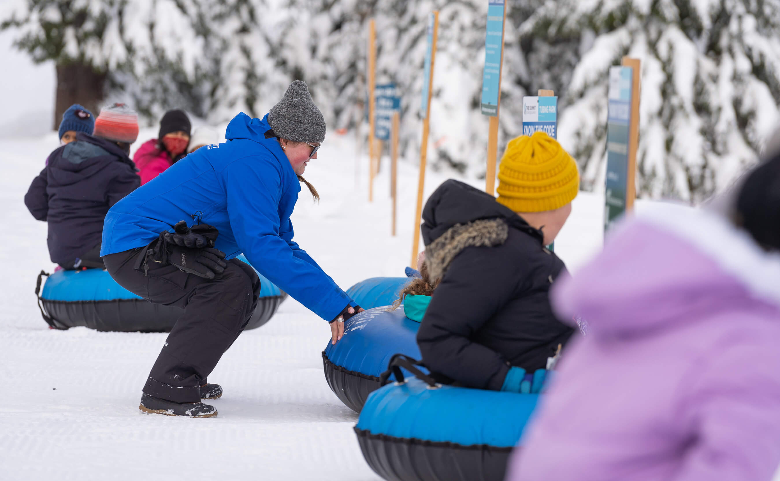 Staff helping snow tuber