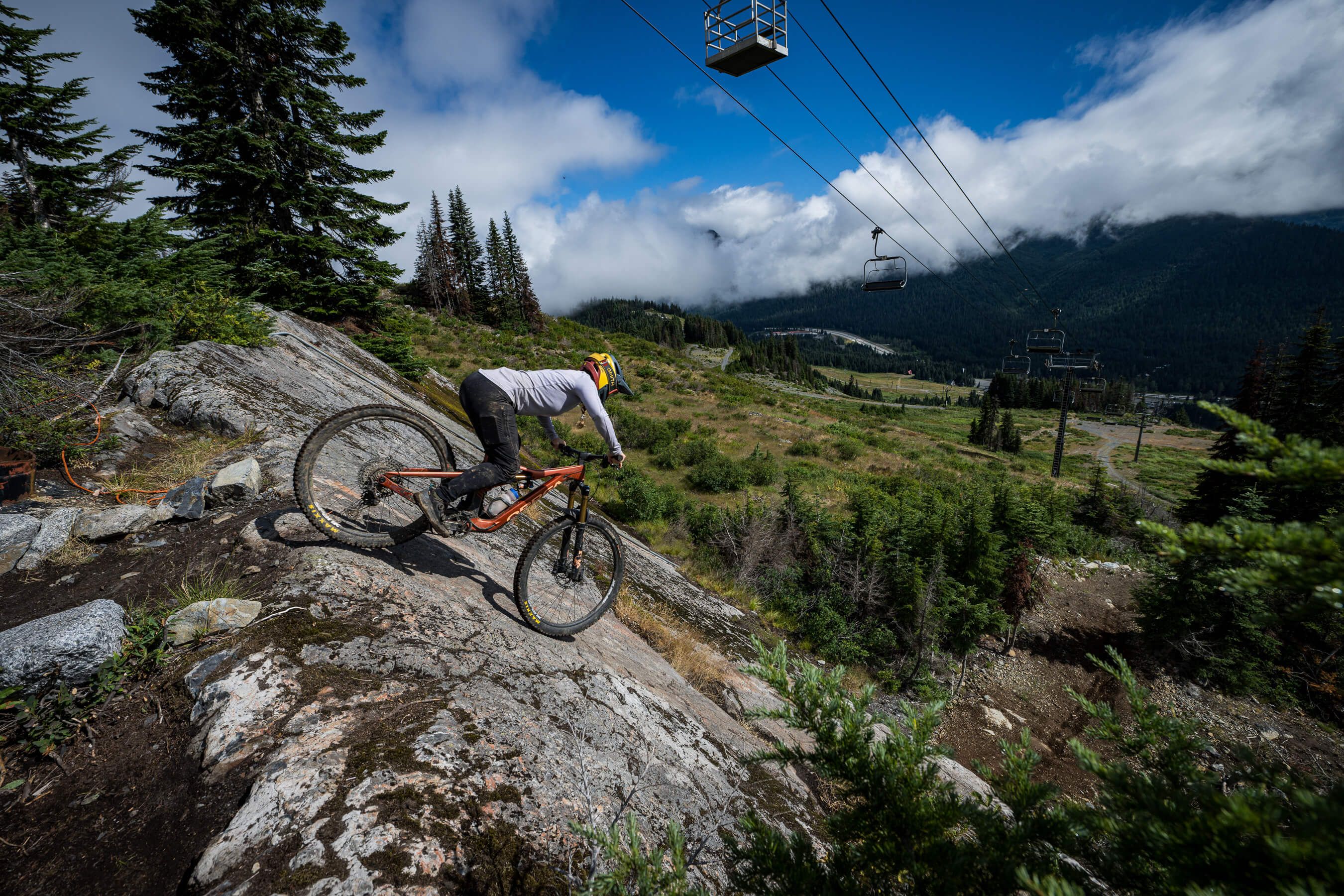 biker on slab with chairlift overhead