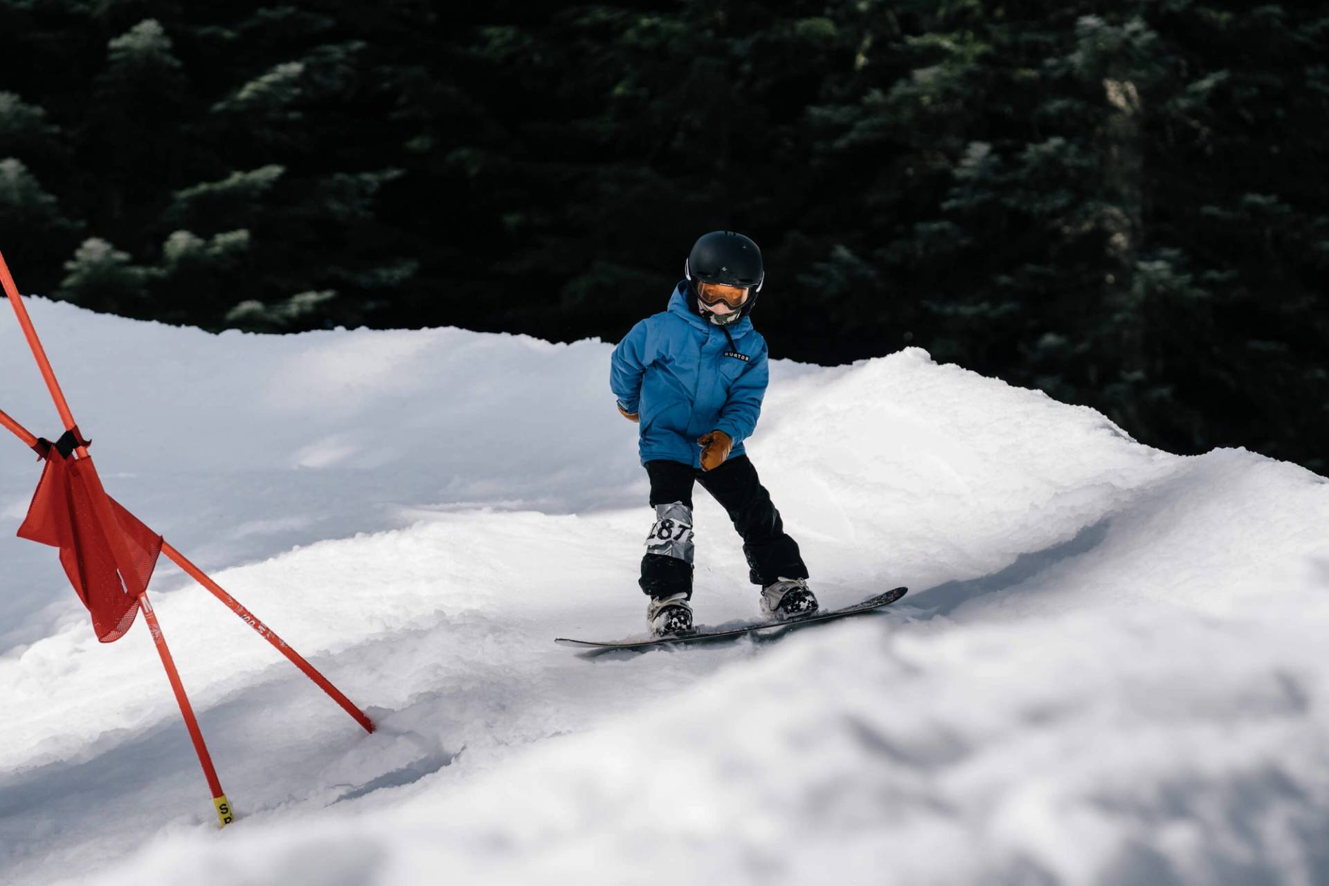 youth competitor navigates turn on banked slalom course