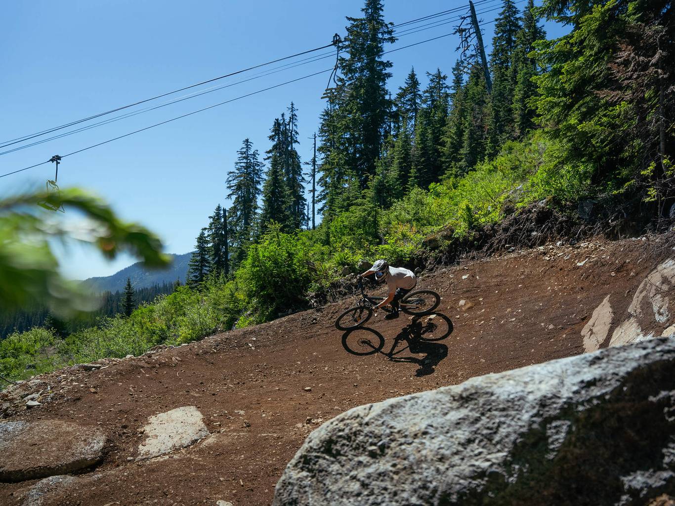 mountain biker in berm below chairlift at The Summit