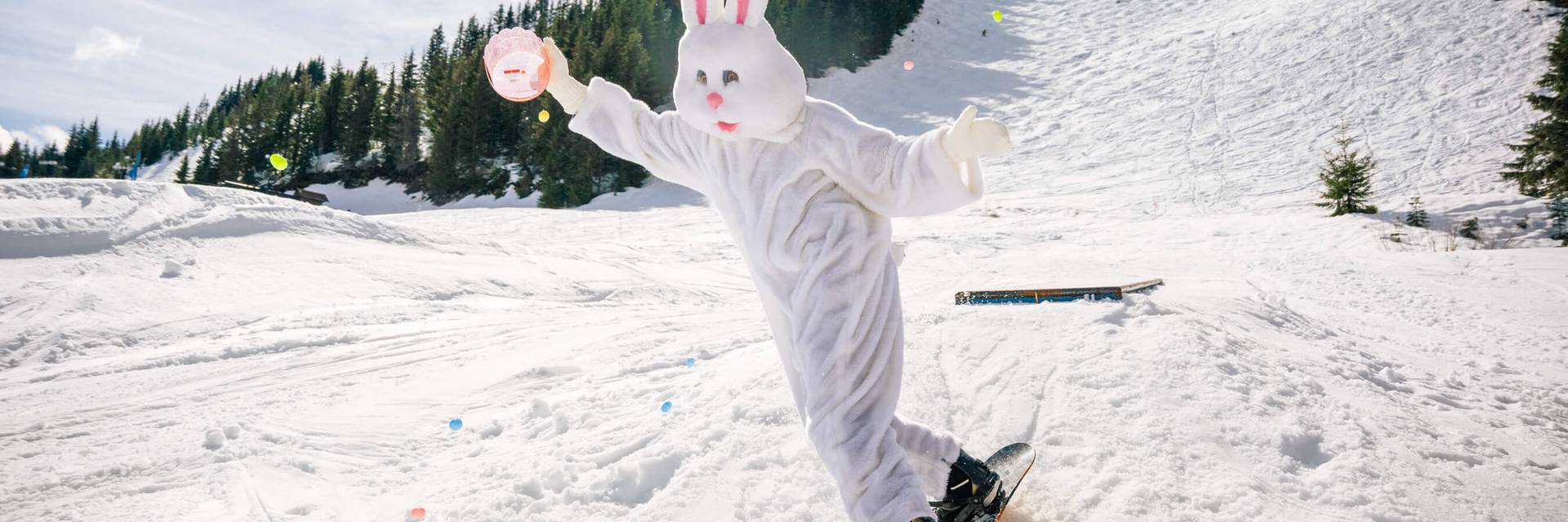 Easter bunny on a snowboard on a sunny day at Summit Central
