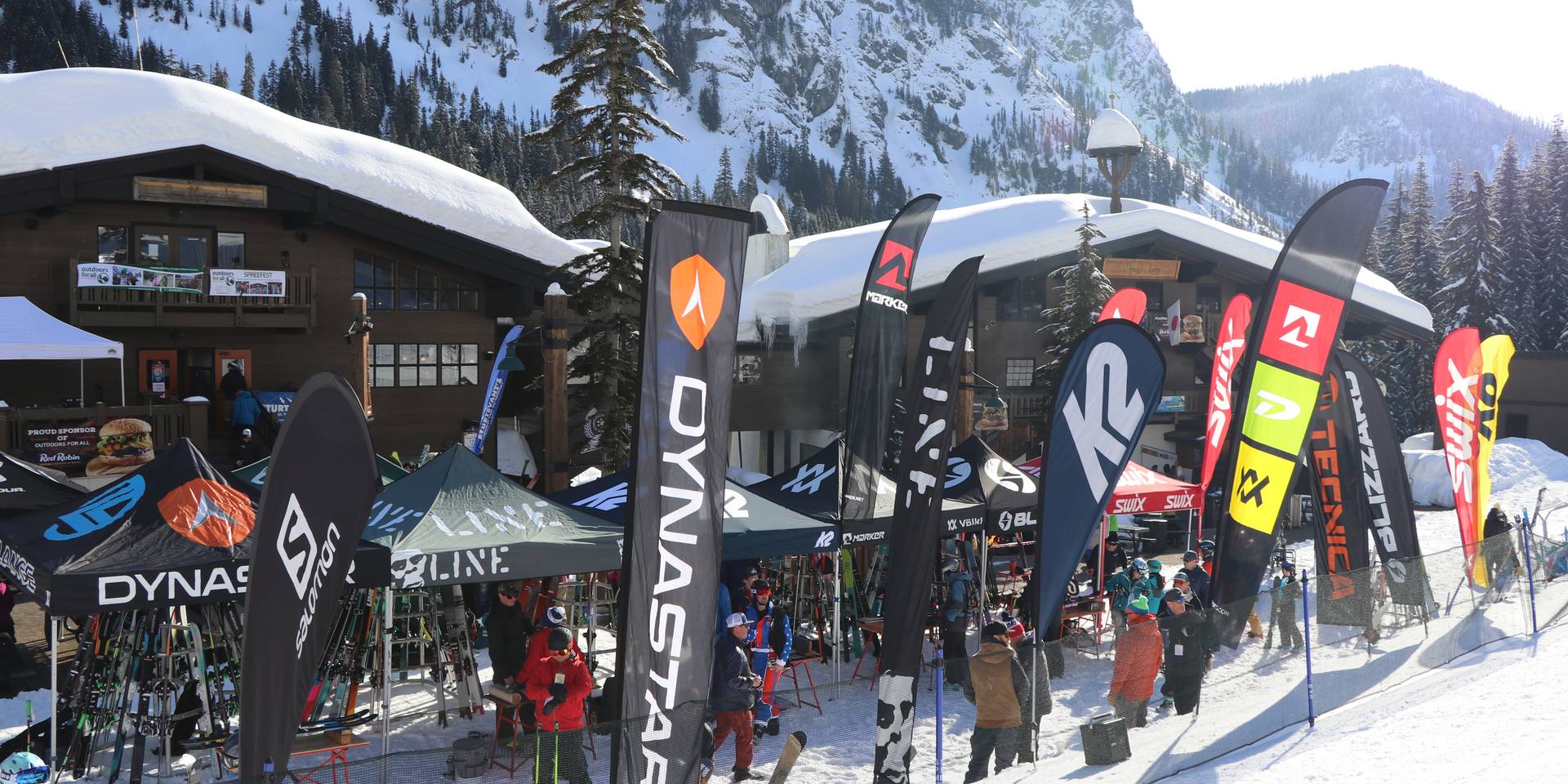 Spreefest vendor village demo booths set up on snow in front of lodges at Alpental.