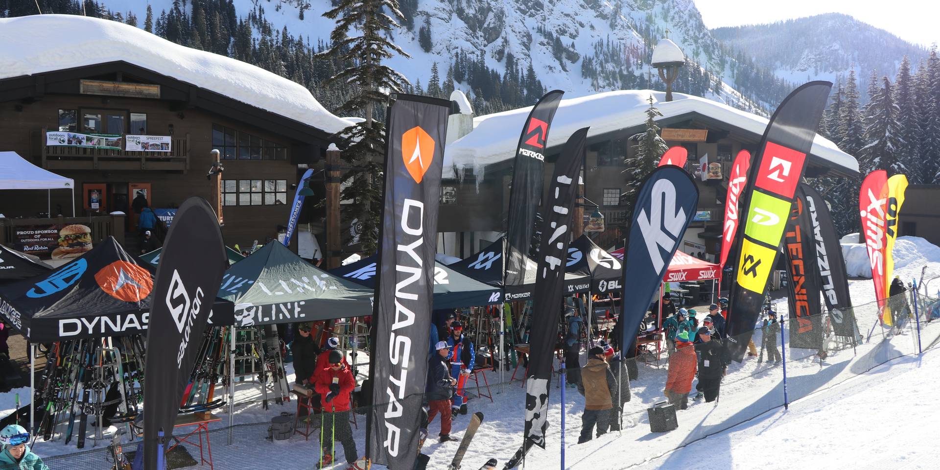 Spreefest vendor village demo booths set up on snow in front of lodges at Alpental.