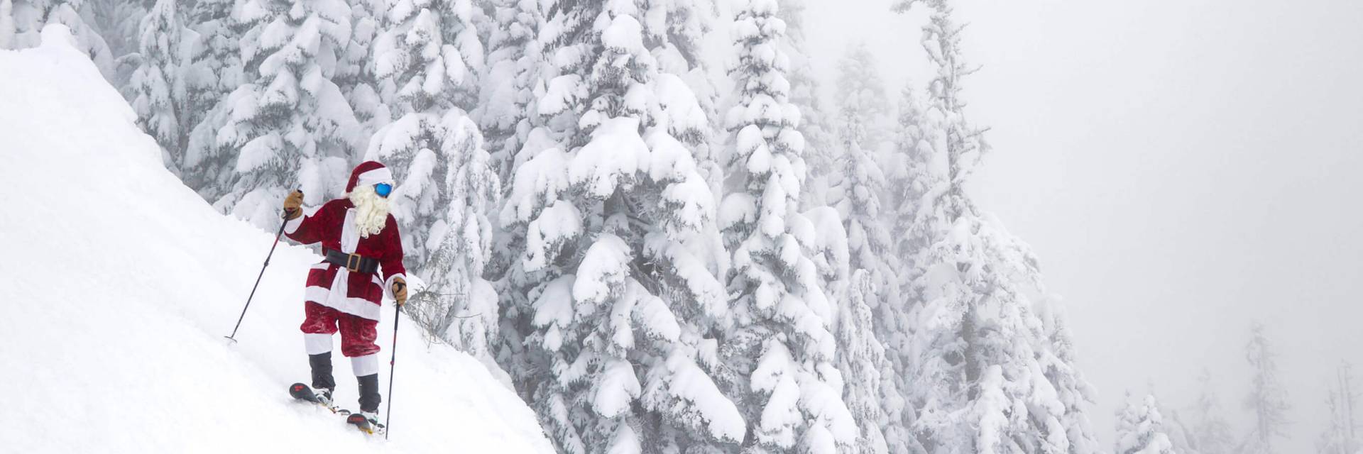 Santa on skis stopped on steep slope