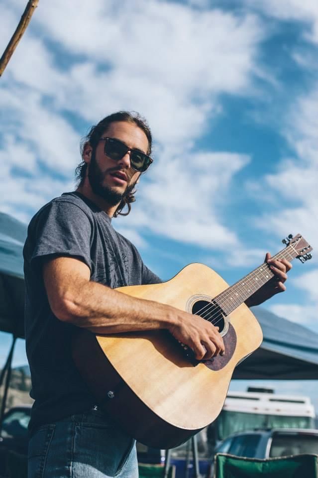 musician with guitar outside