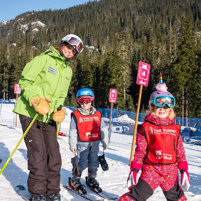 summit leadership student with ski school students