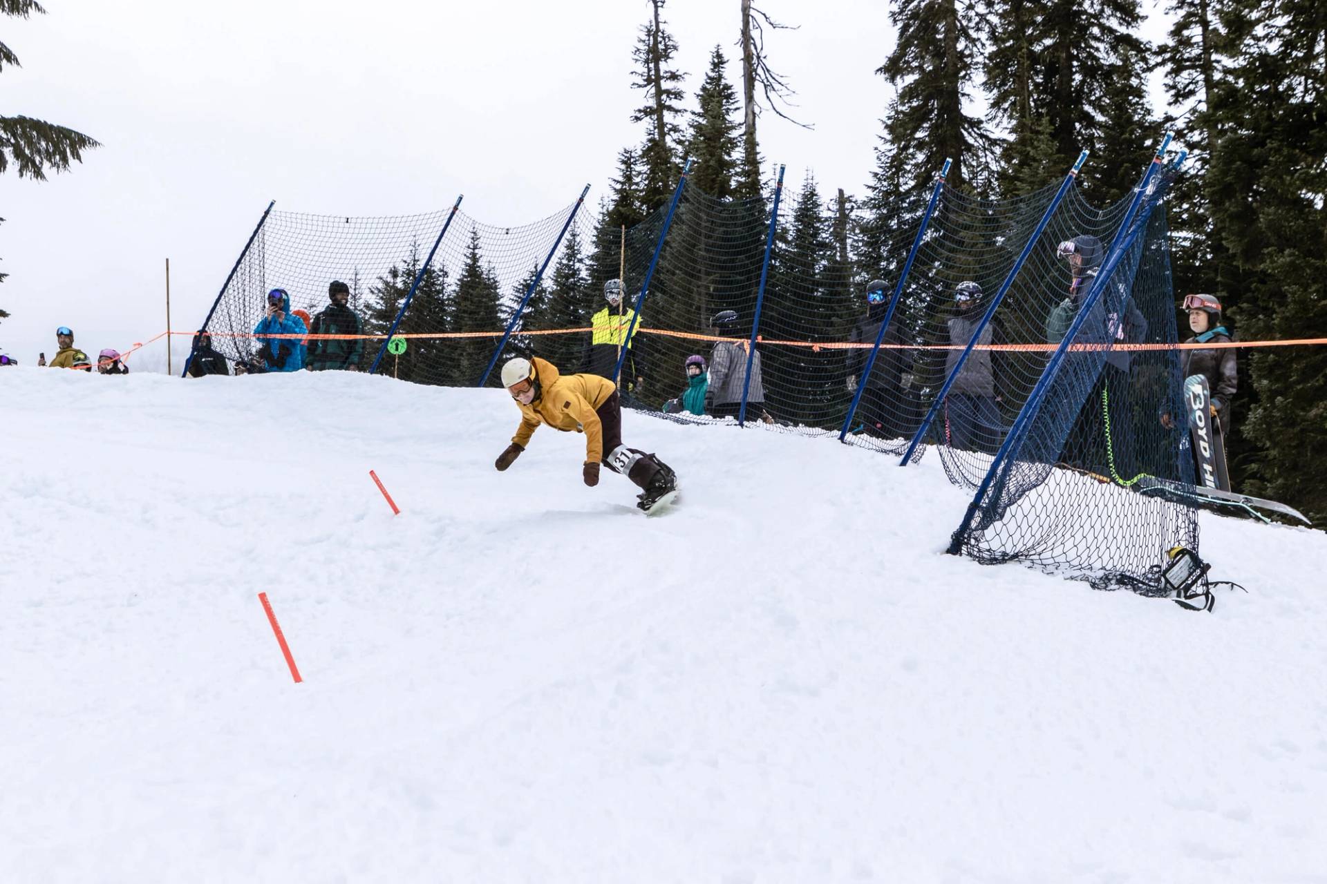 snowboarder gets low through a banked slalom turn 