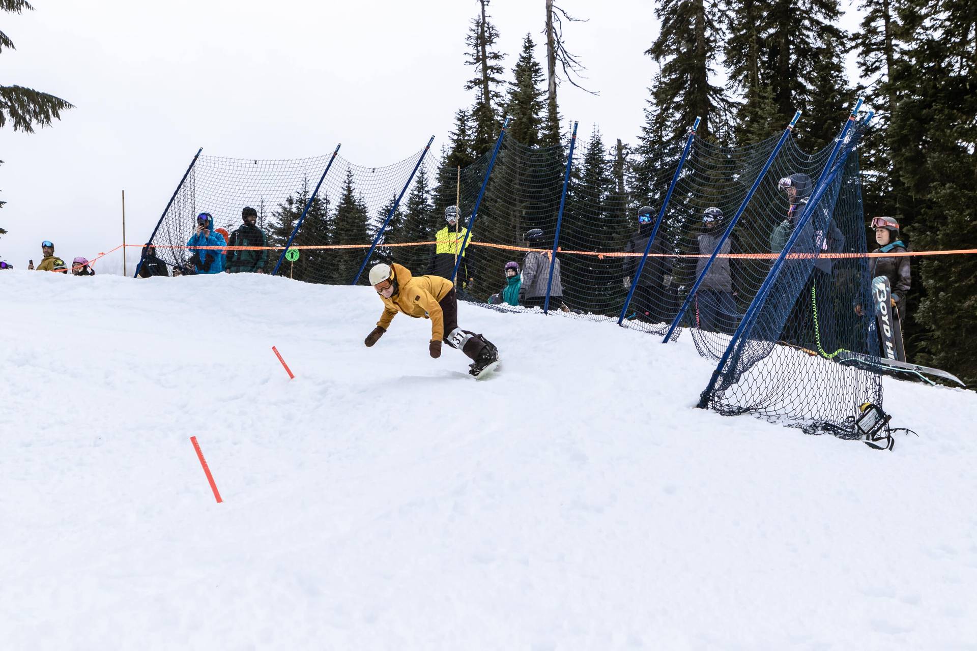 snowboarder gets low through a banked slalom turn