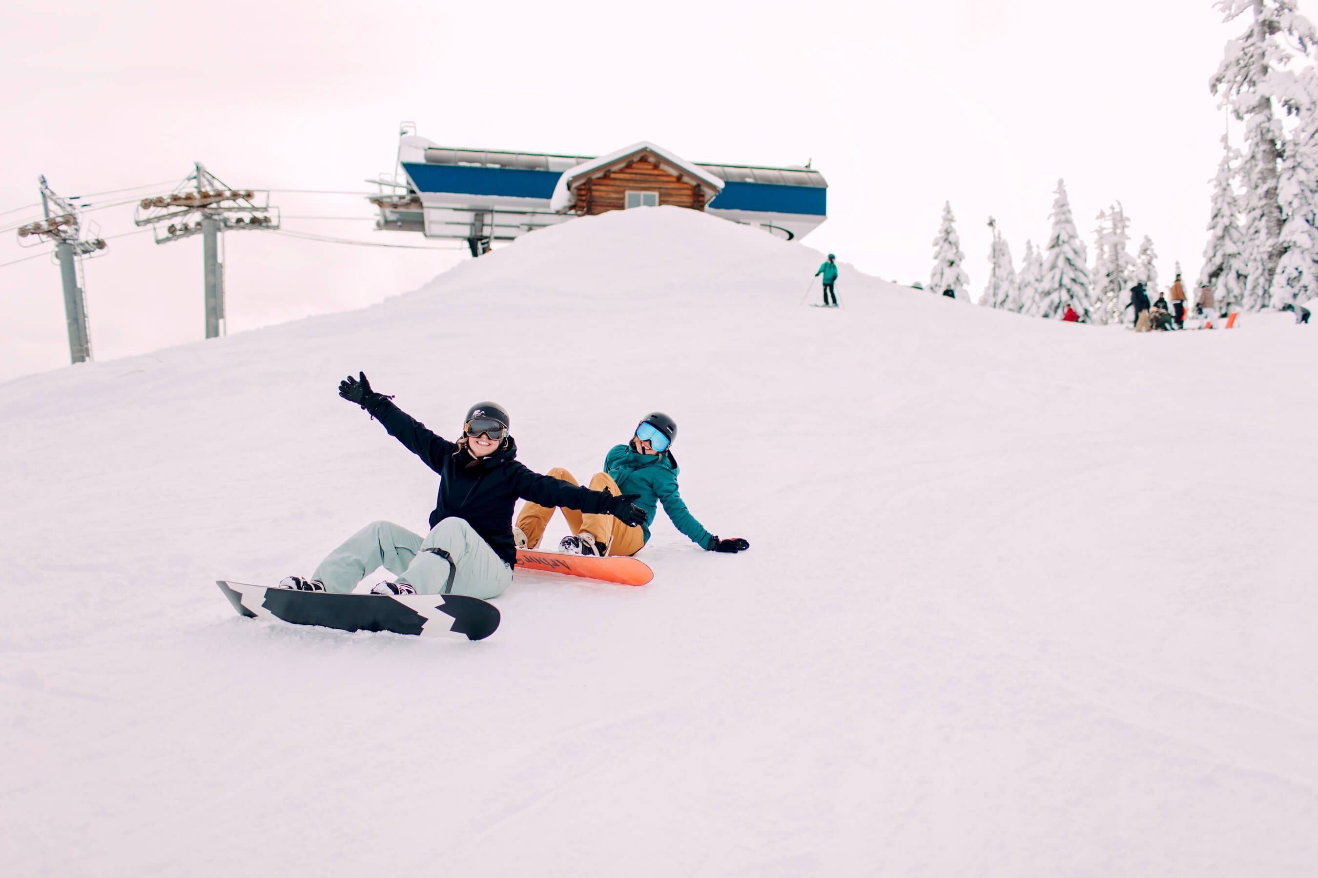people on chairlift with people skiing underneath