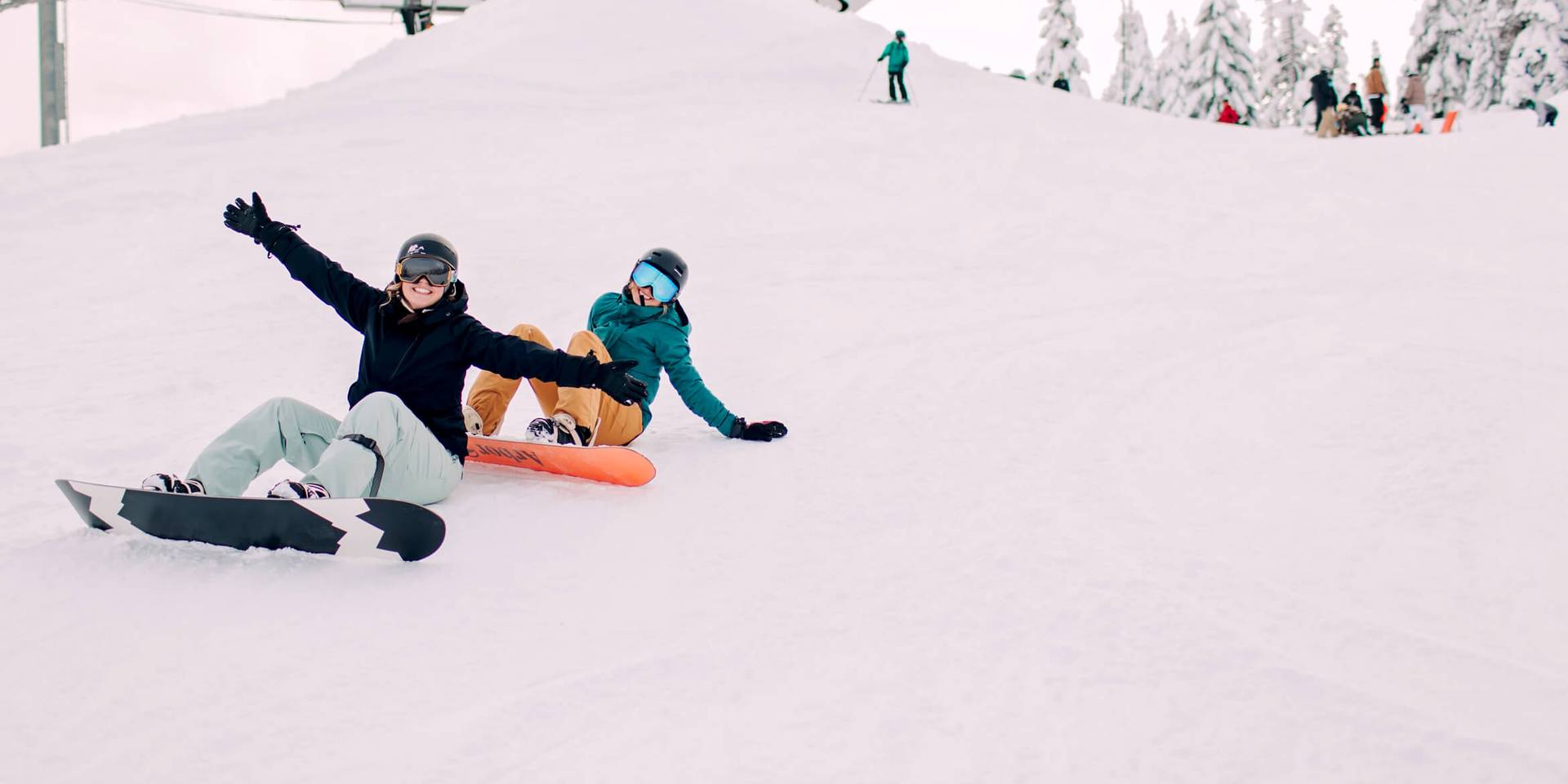 people on chairlift with people skiing underneath