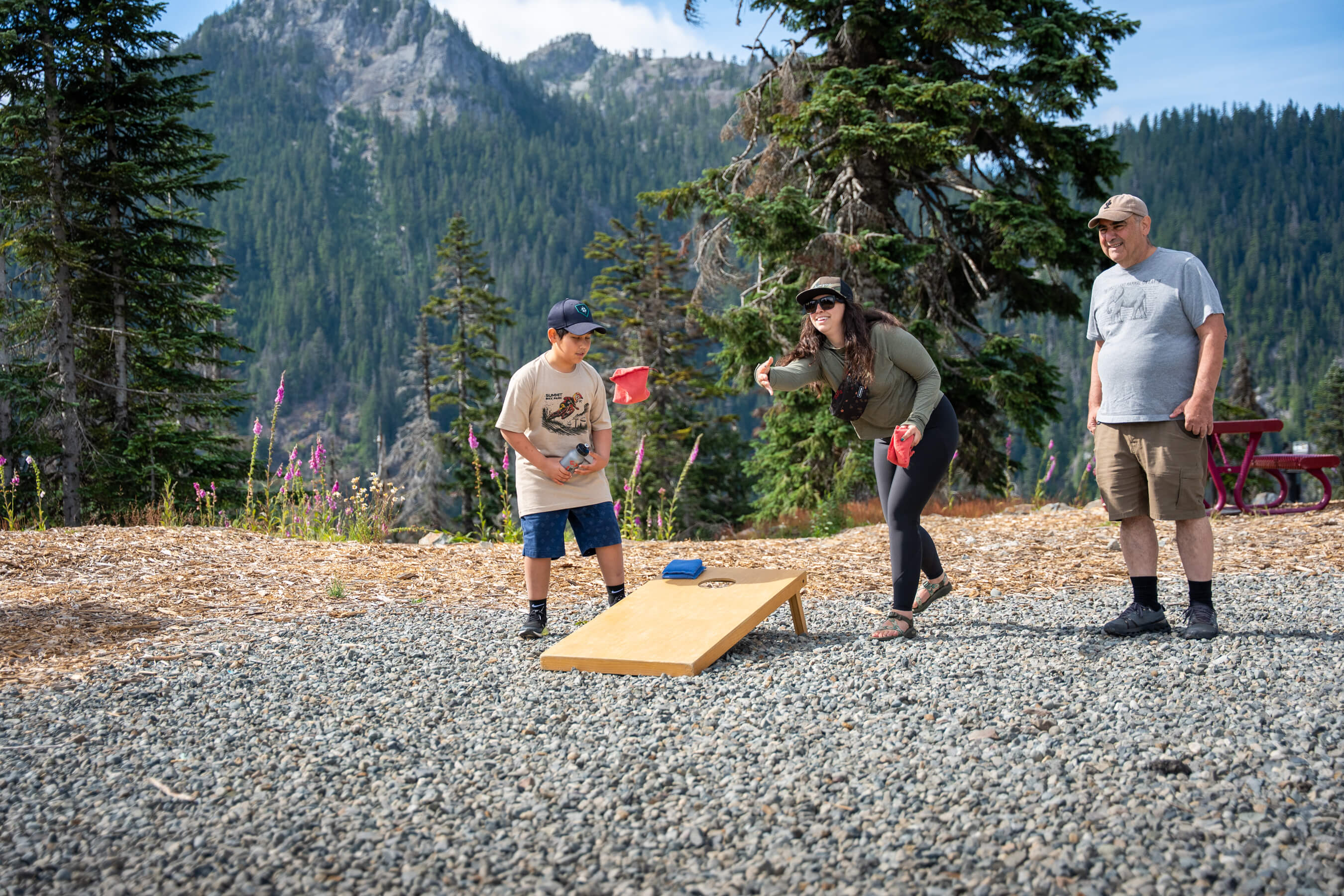 family playing cornhole