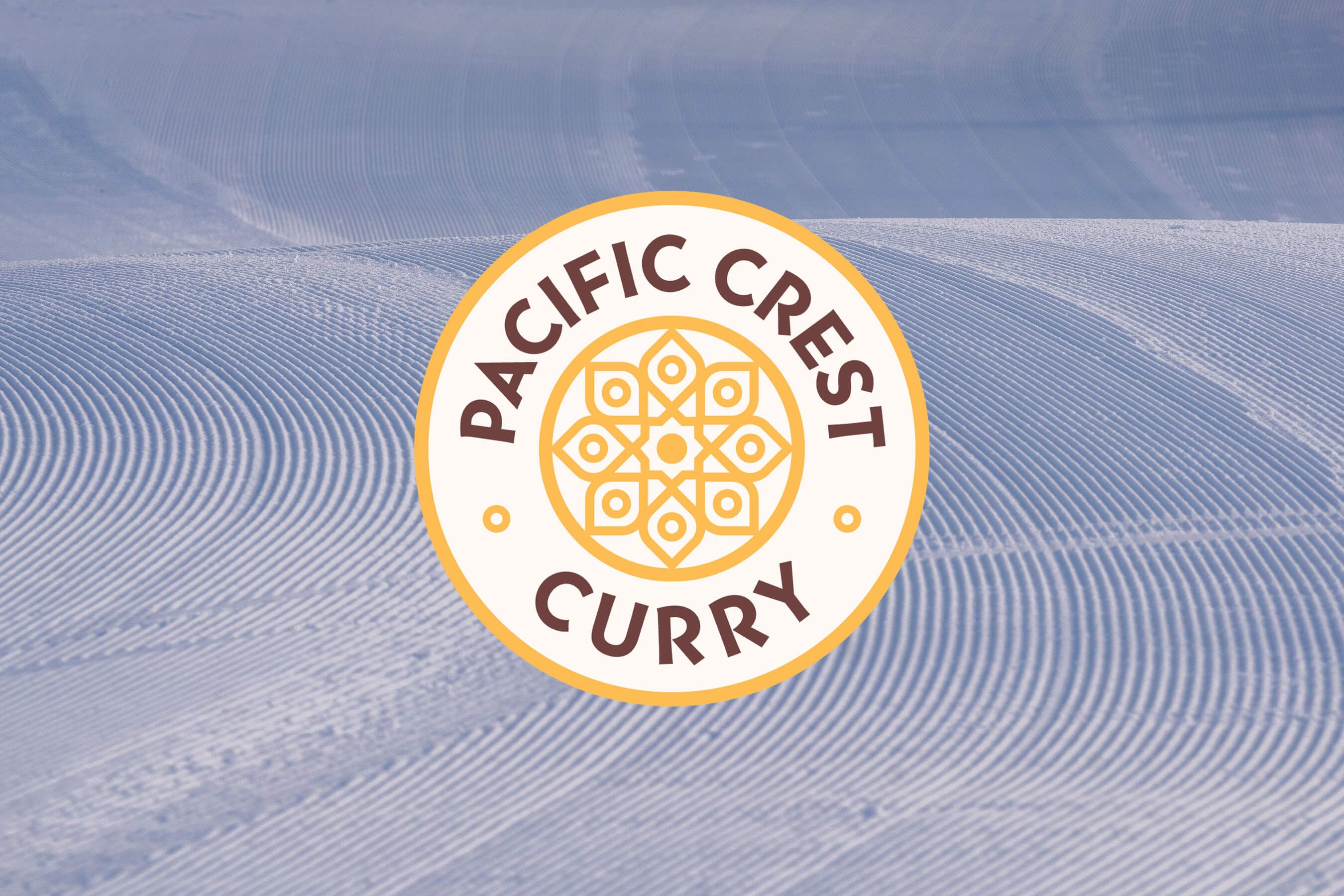 pacific crest curry logo over corduroy on snow