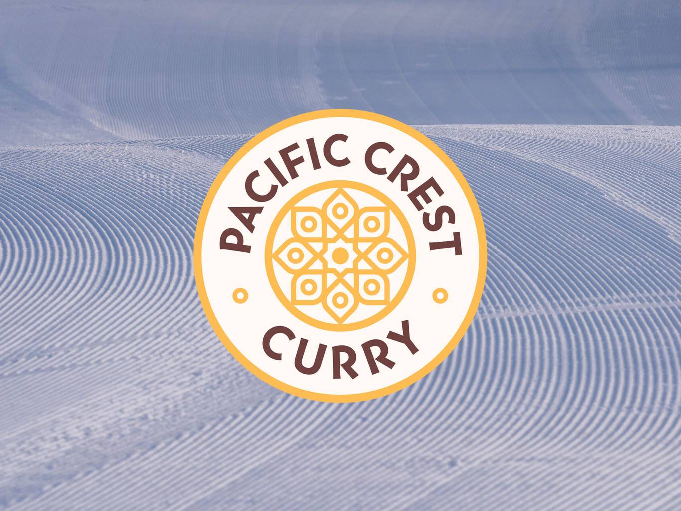 pacific crest curry logo over corduroy on snow