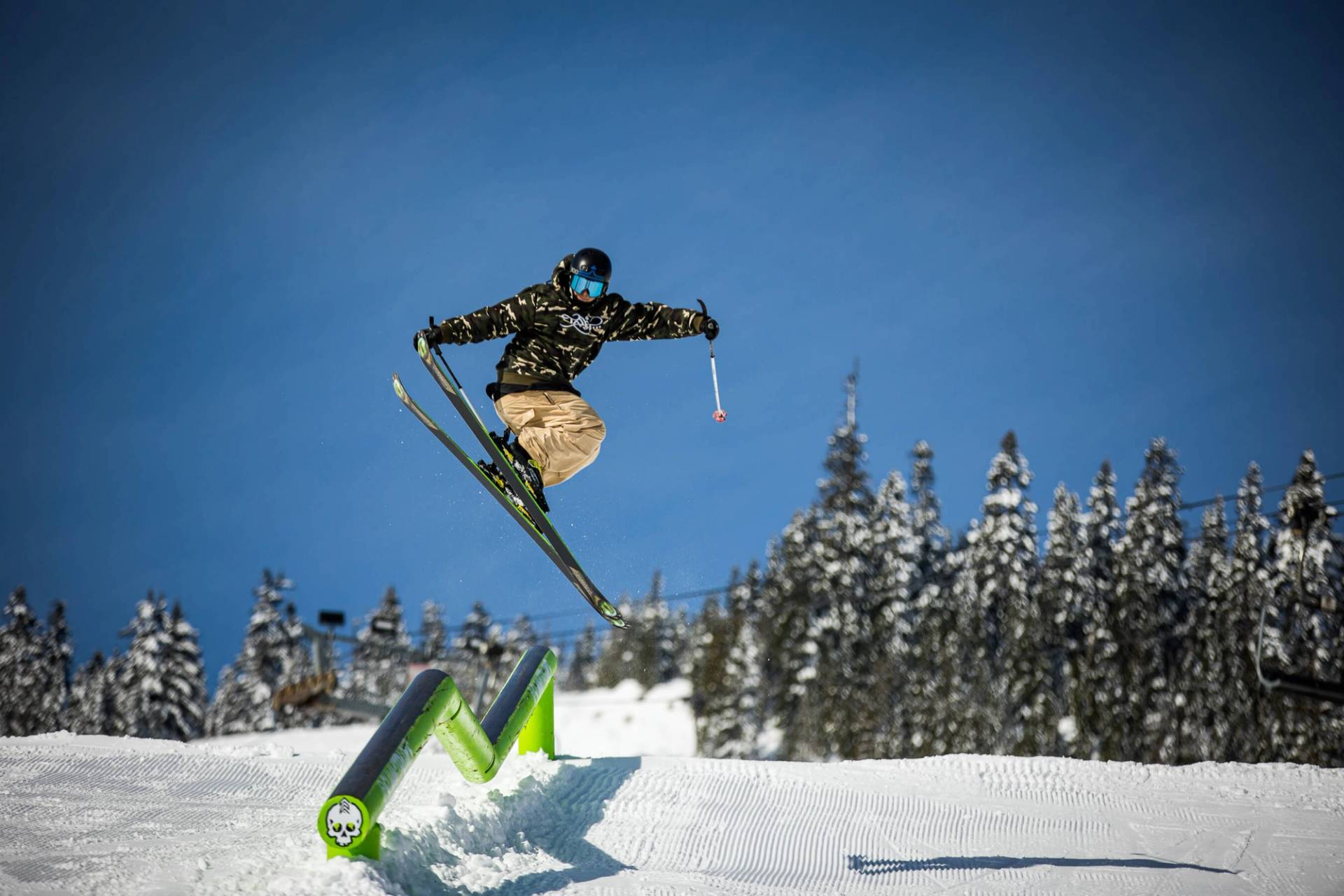 skier hitting rail in terrain park