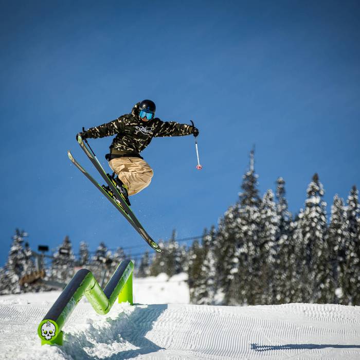 skier hitting rail in terrain park