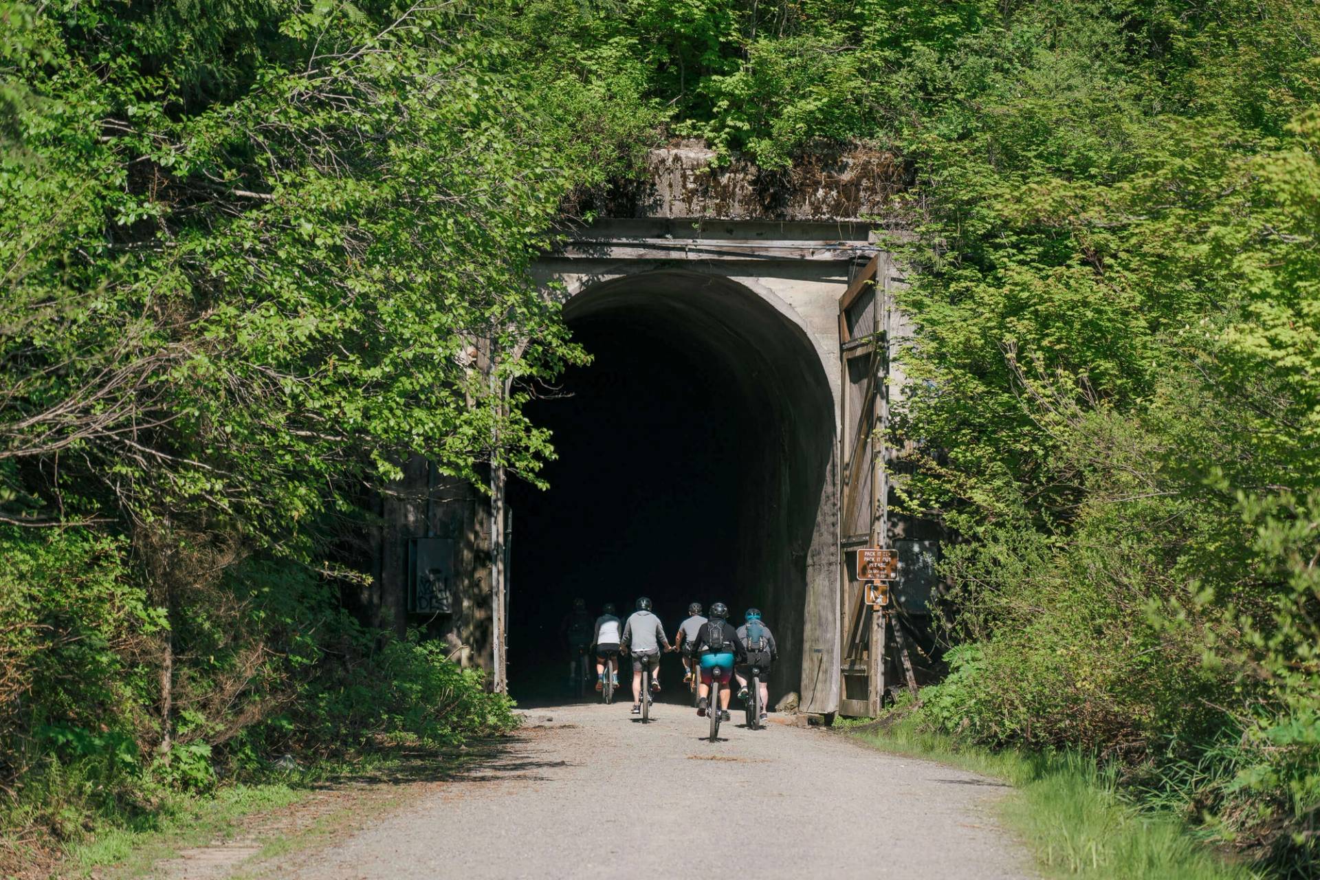 group of cyclists entering tunnel