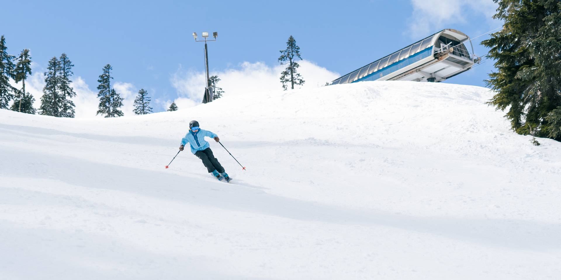 girl in blue jacket carving down groomer under central express