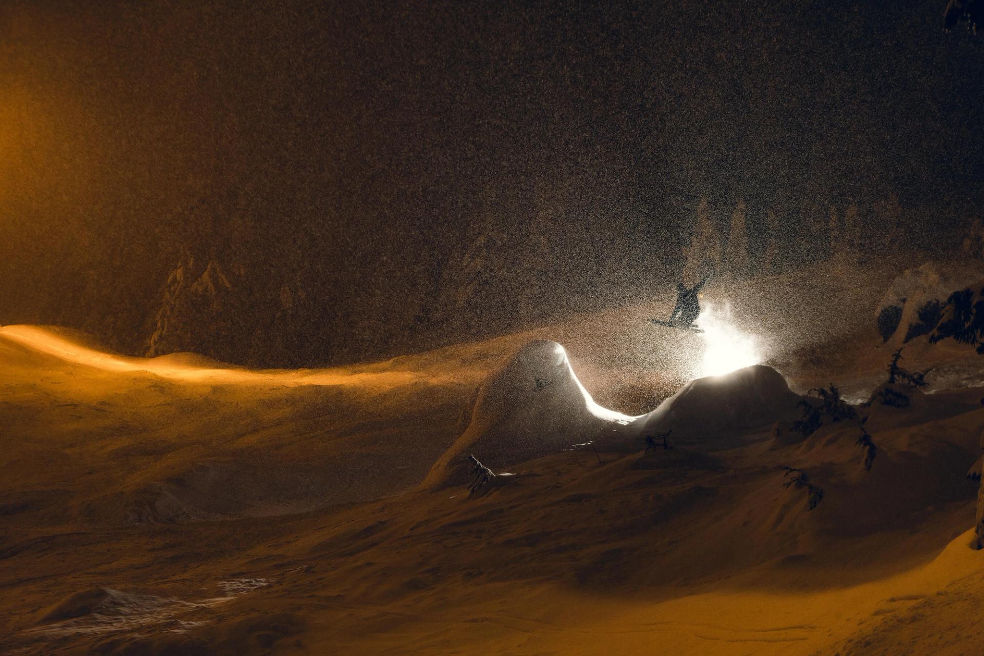 light burst skier on snowy day getting air