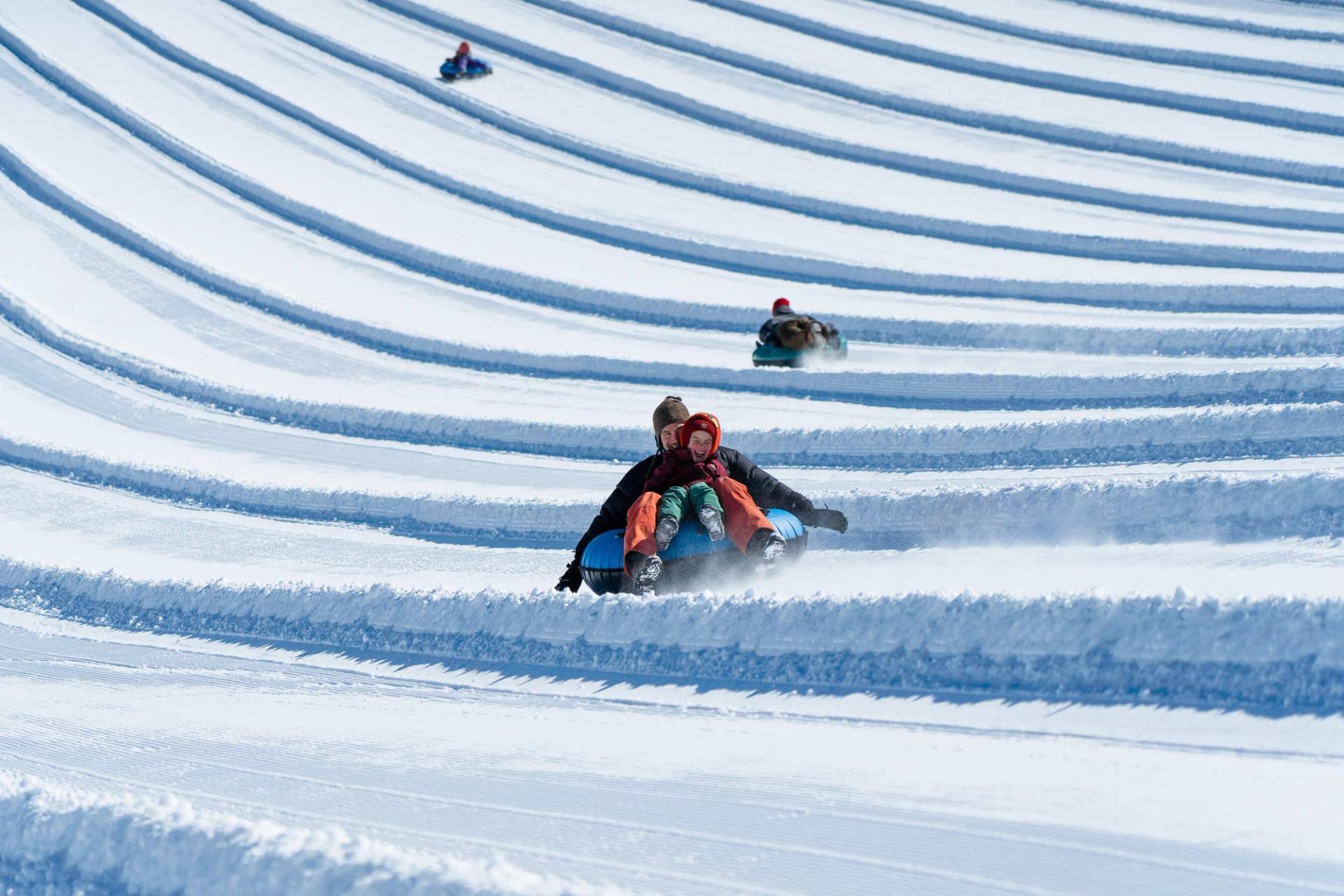 happy kid tubing with dad