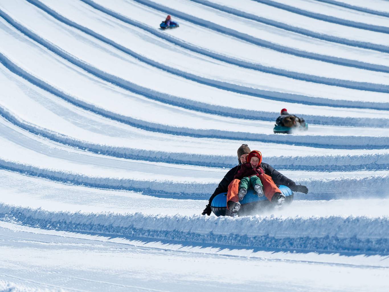 happy kid tubing with dad