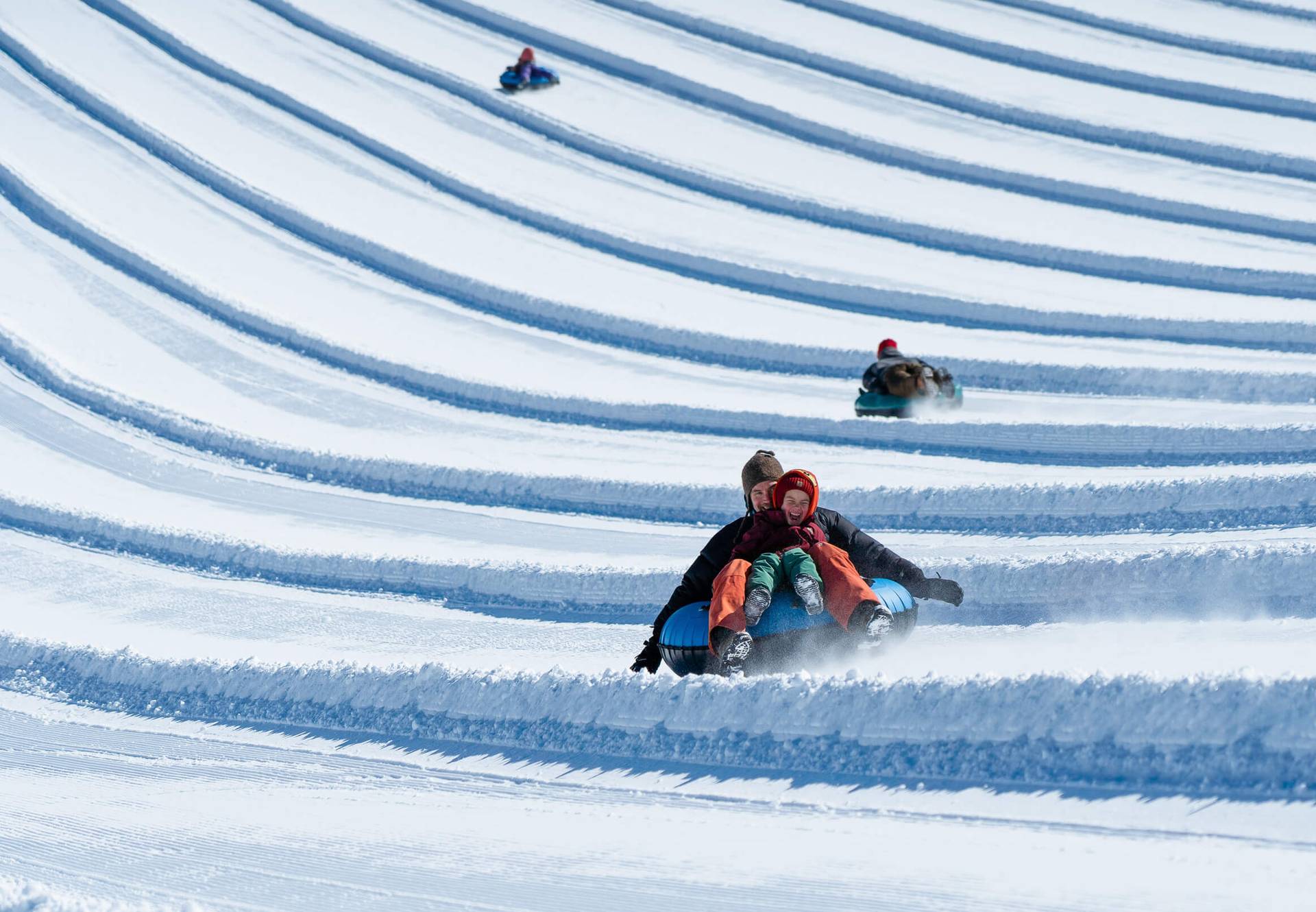 happy kid tubing with dad