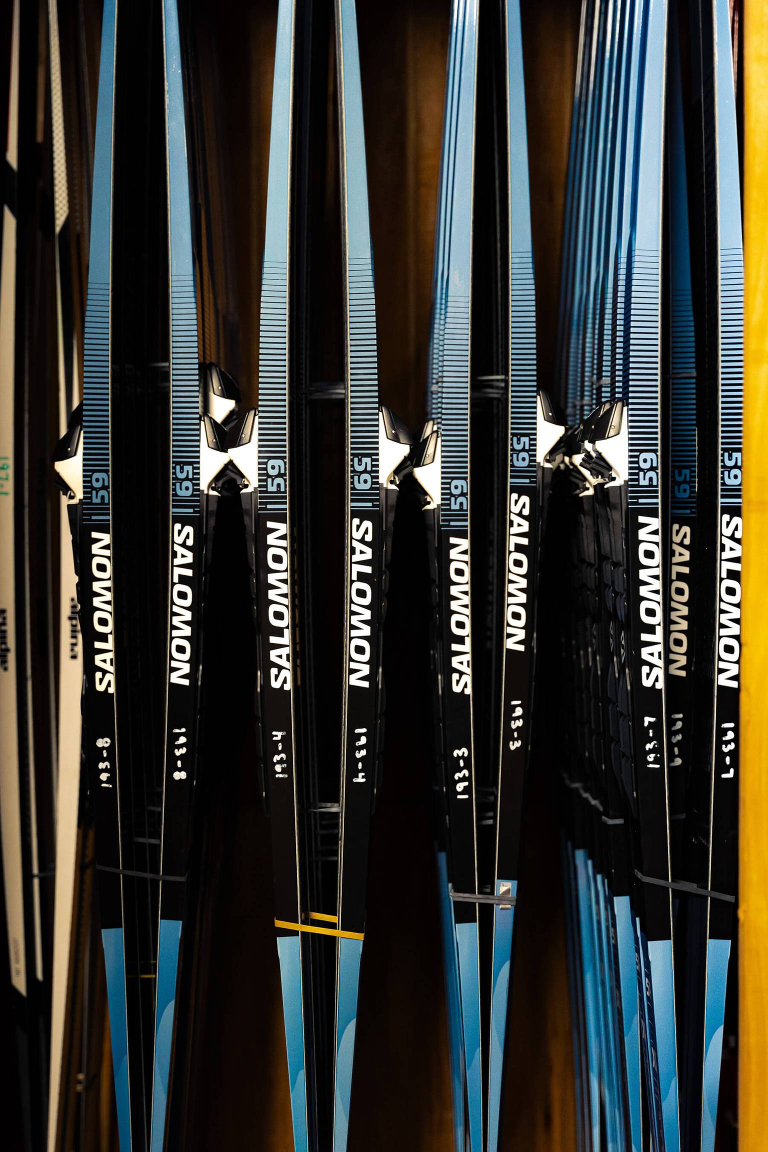 nordic rental skis on rack in rental shop