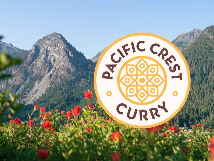 pacific crest curry logo over scenic image of guye peak in summer