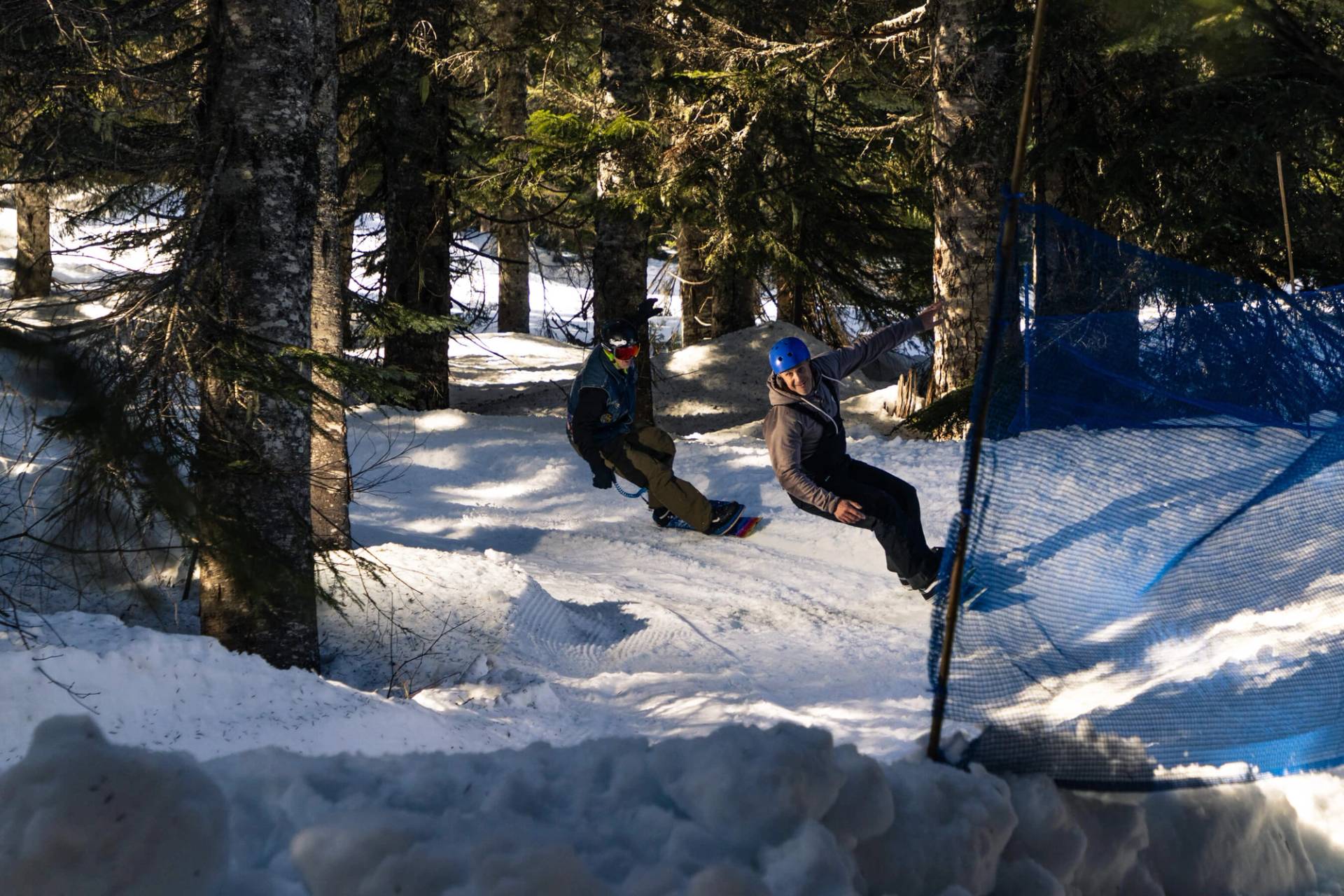 snowskaters in the trees on serpentine