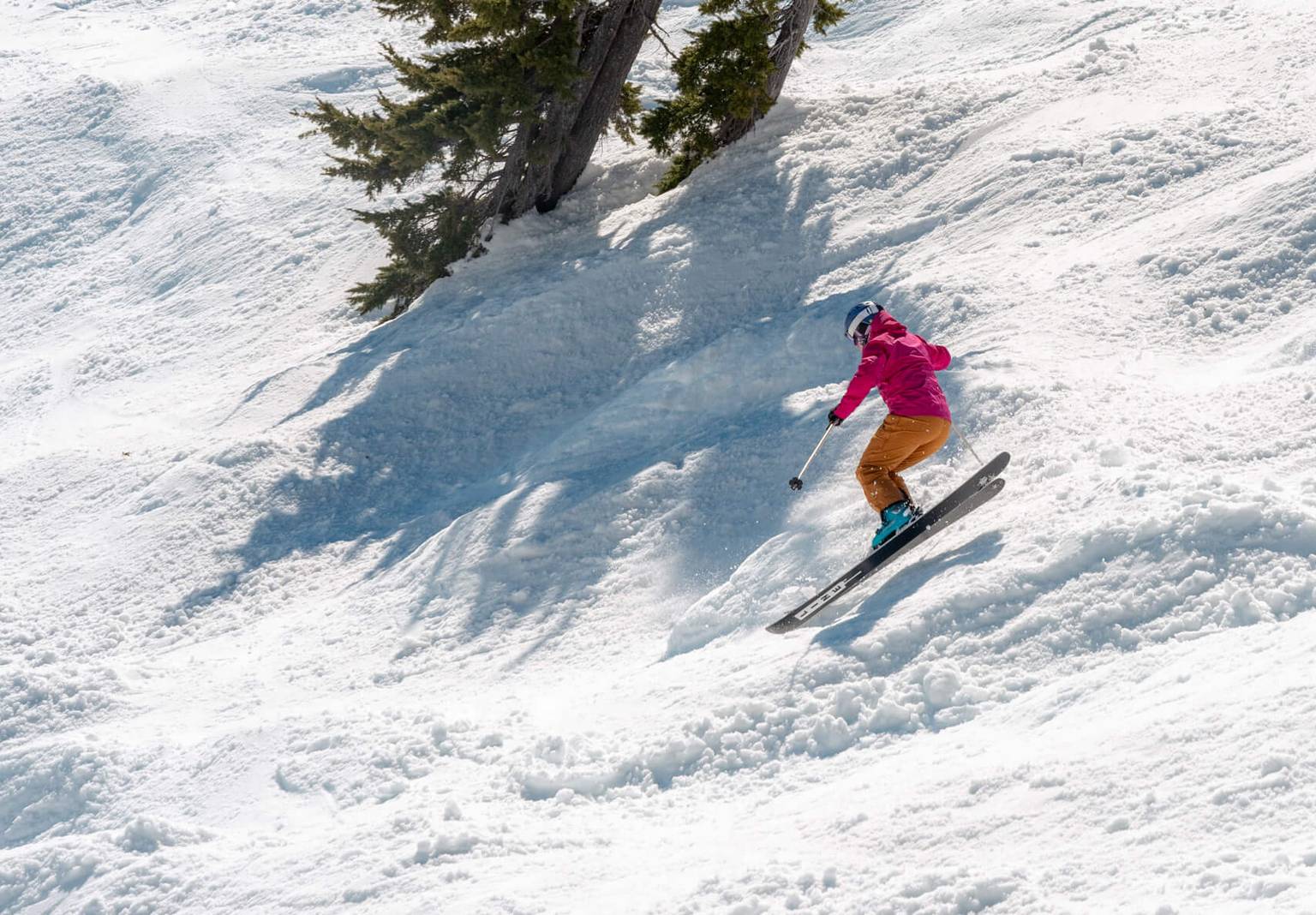 skier jumps on steep slope