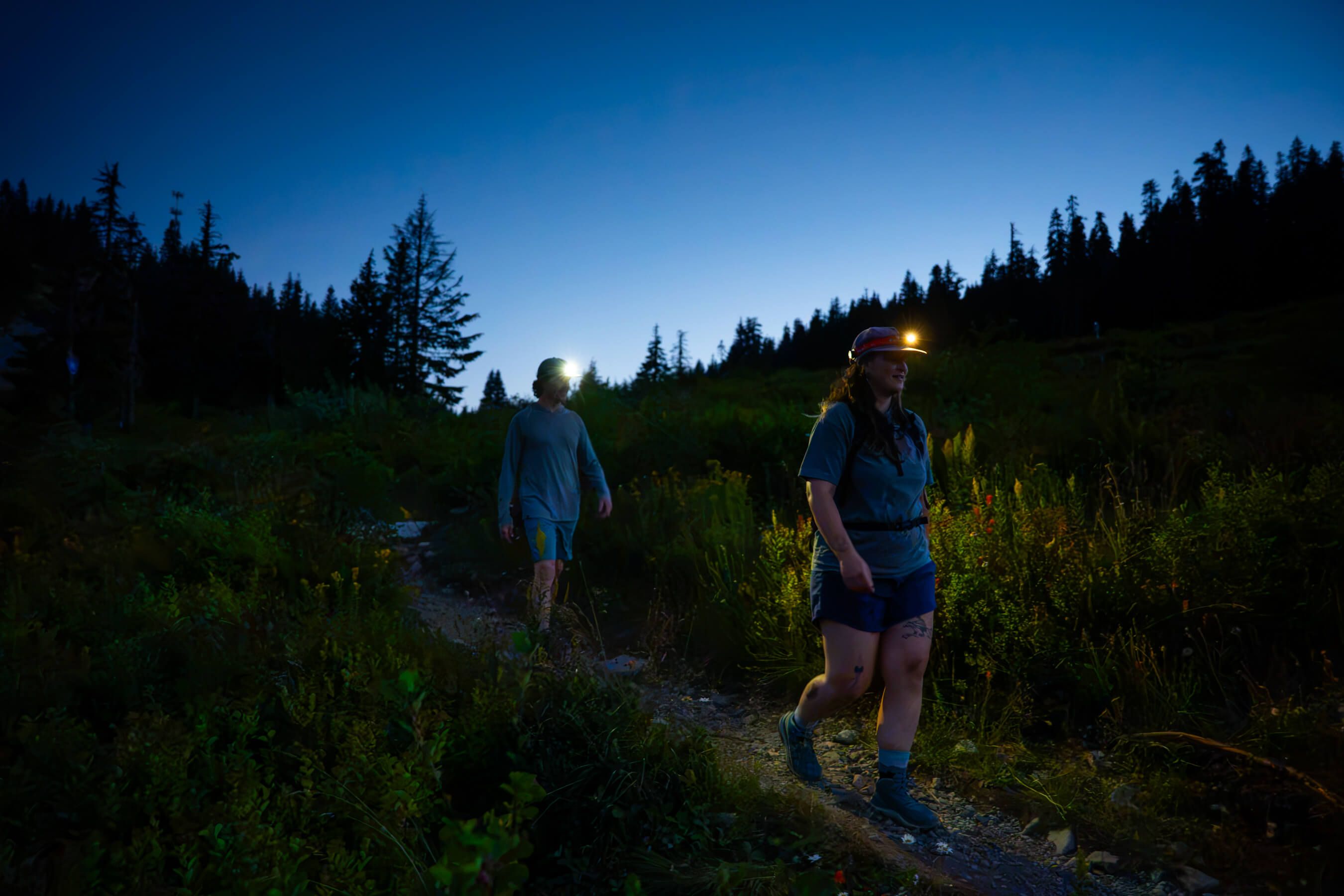 two hikers with headlamps walking on the pacific crest trail