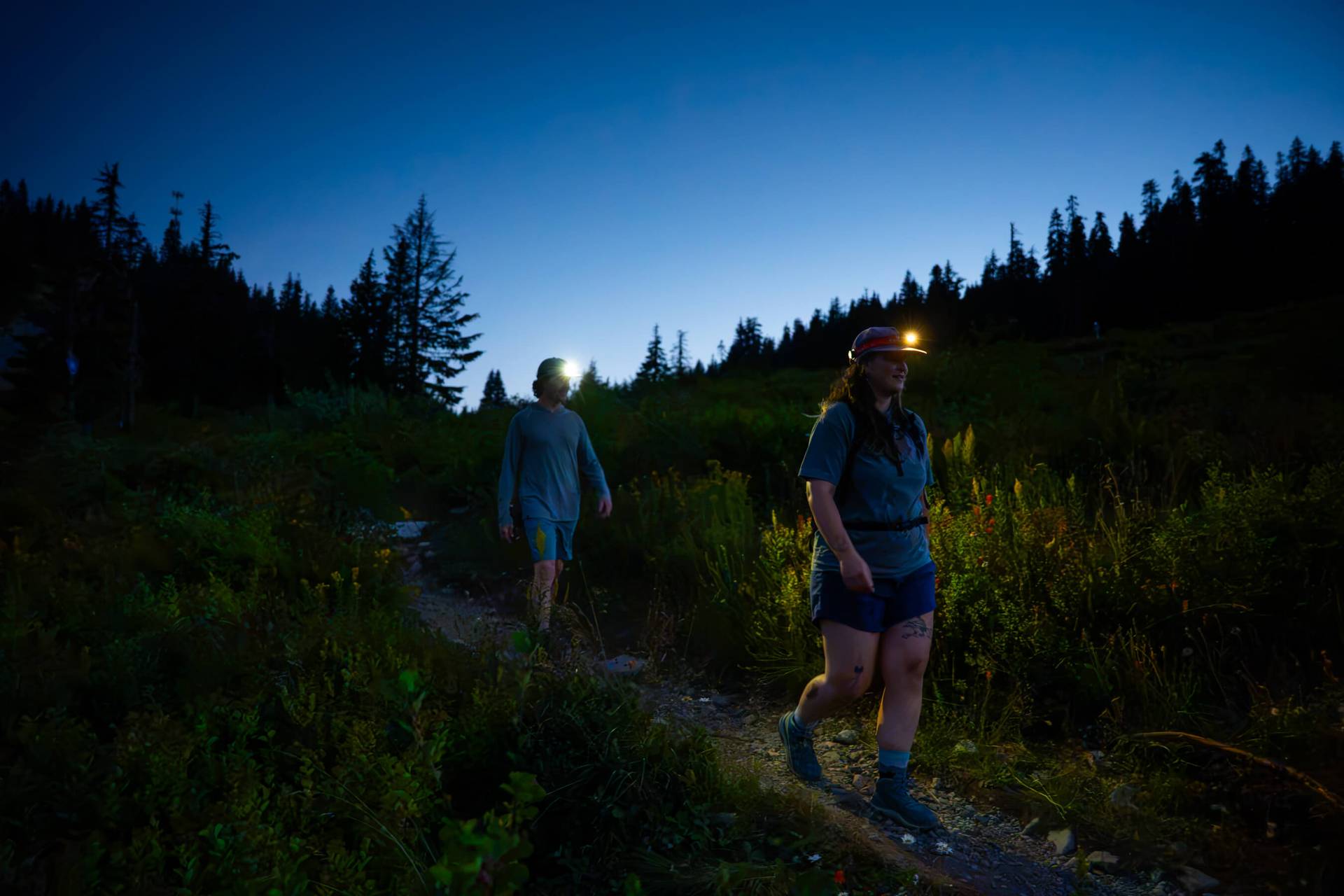 two hikers with headlamps walking on the pacific crest trail