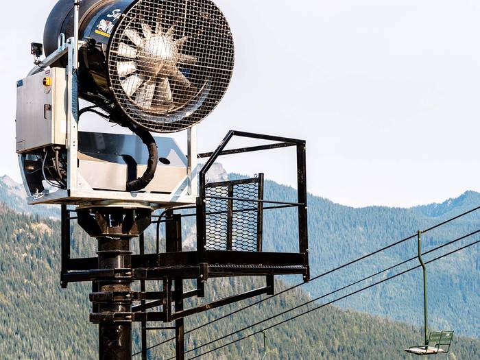 A new snowmaking gun on a tower at Summit West
