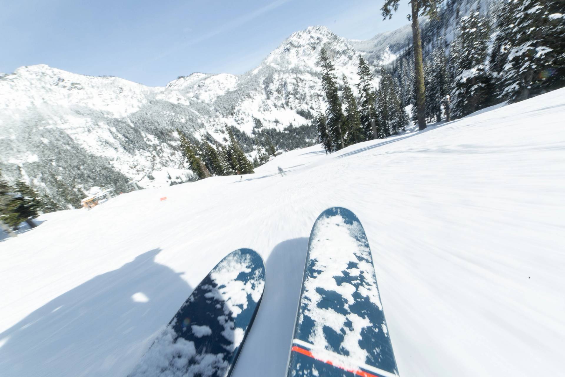 ski tips on groomer view of mountain down valley