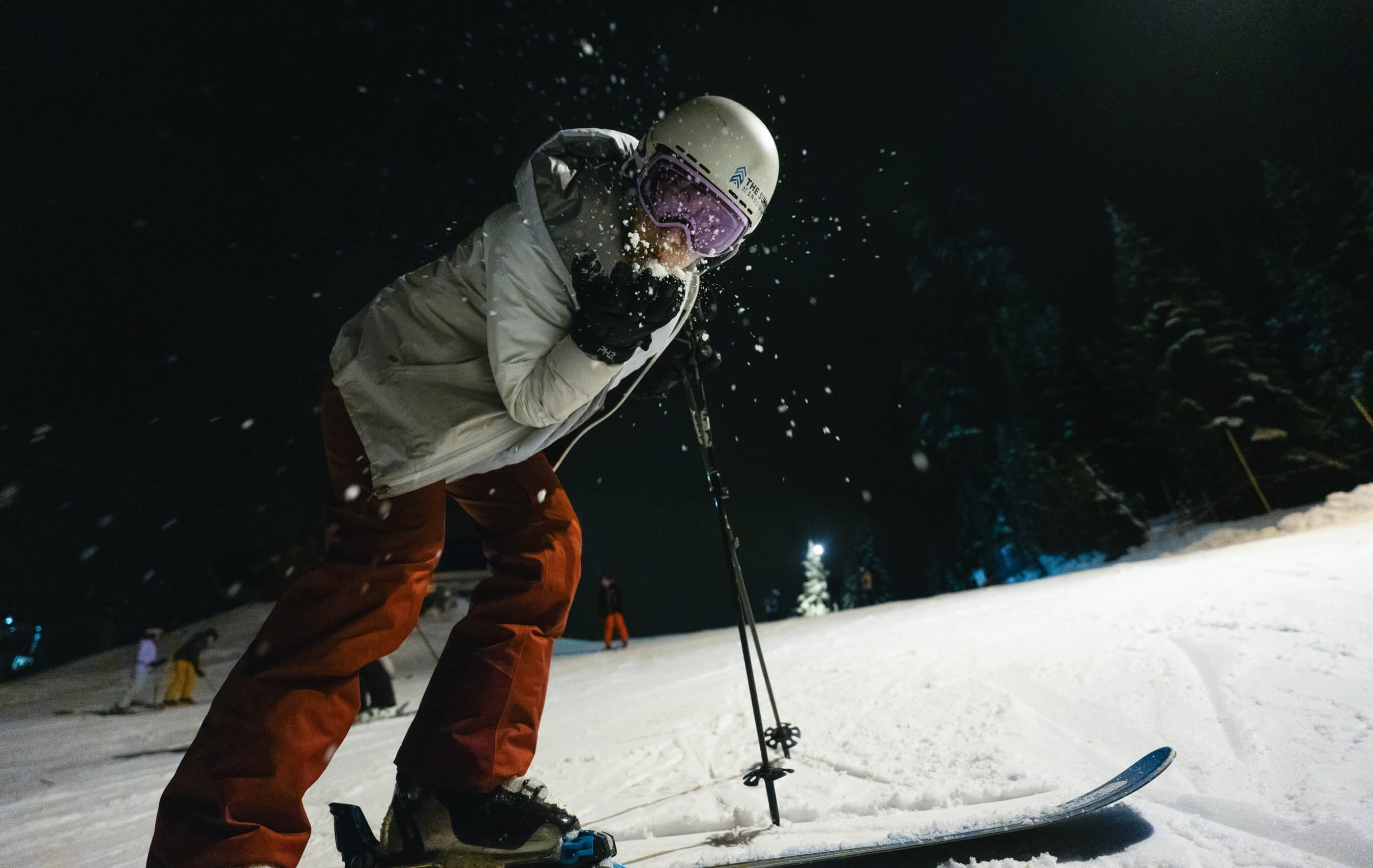 skier hanging out at night on the slopes