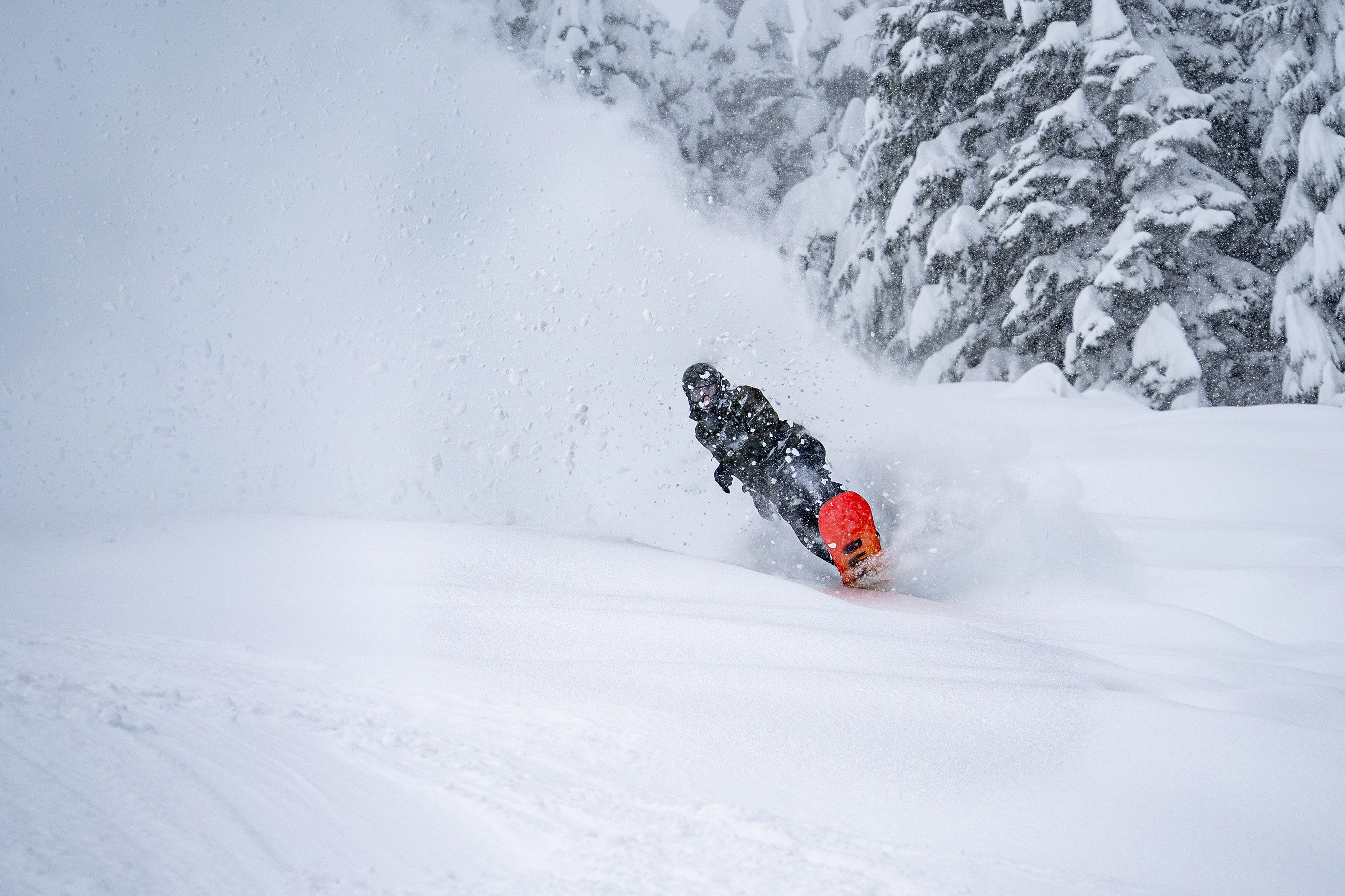 snowboarder wheely out of powder roost