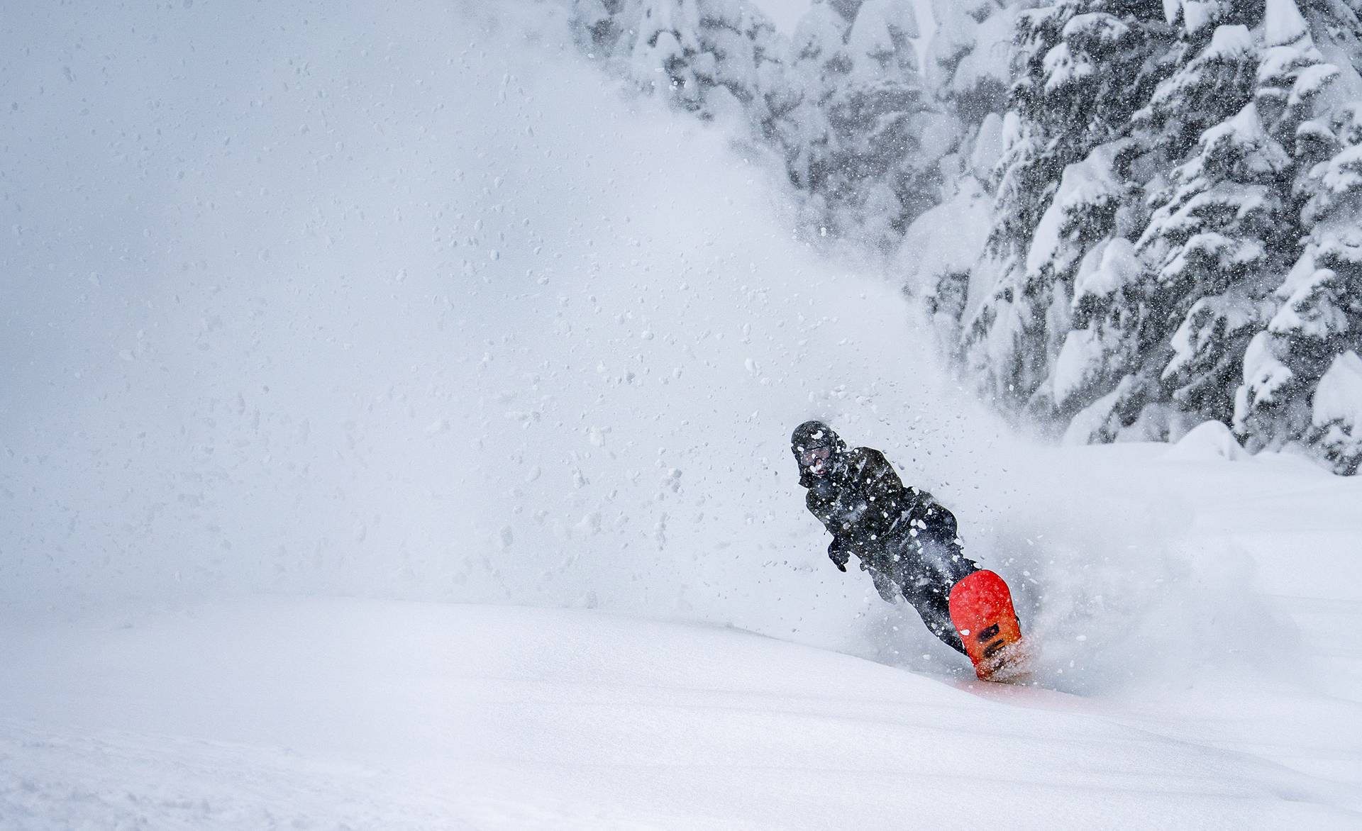 snowboarder wheely out of powder roost
