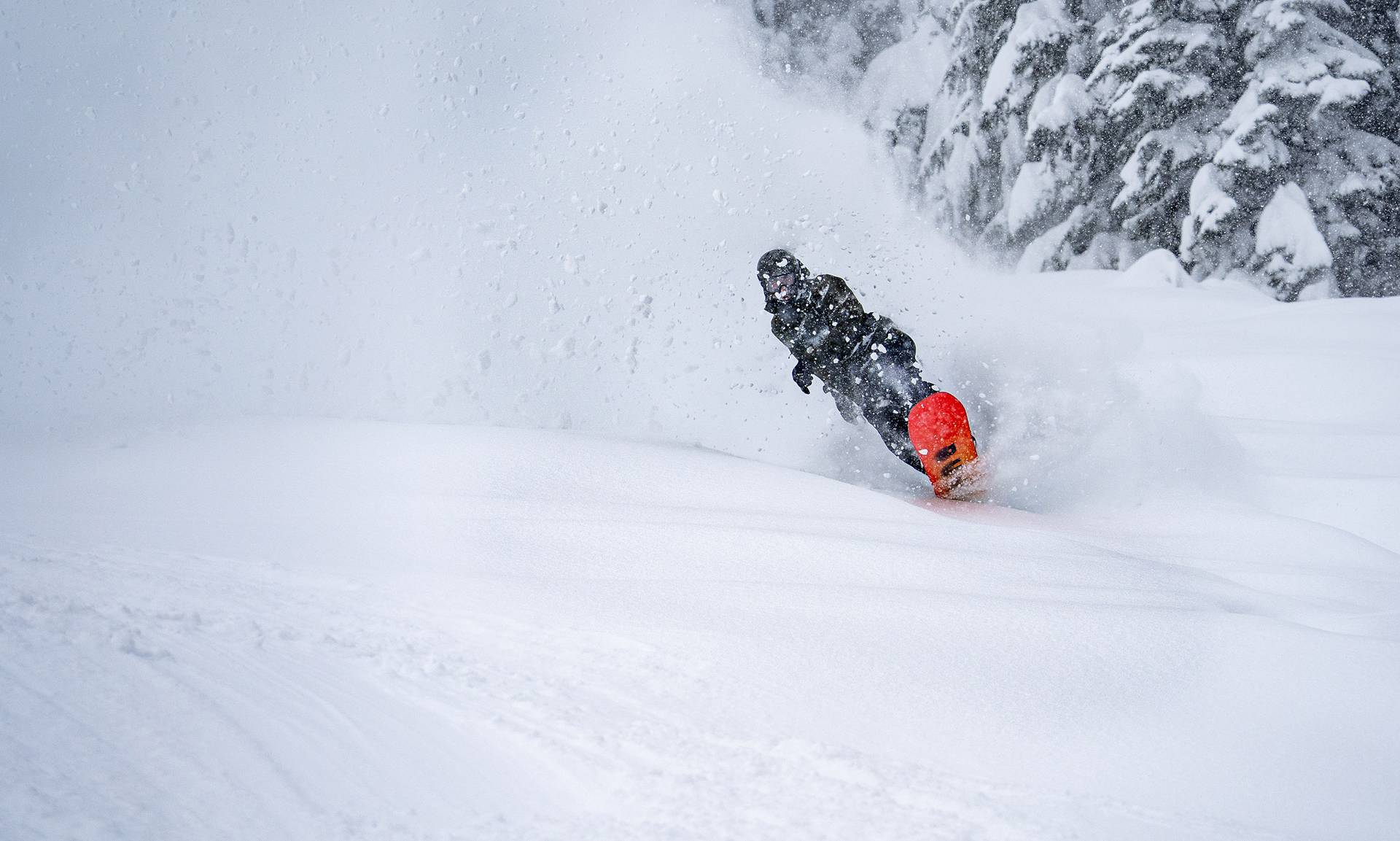 snowboarder wheely out of powder roost