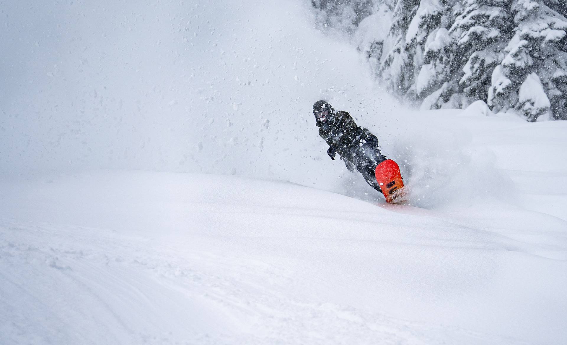 Snowboarder in deep powder turn