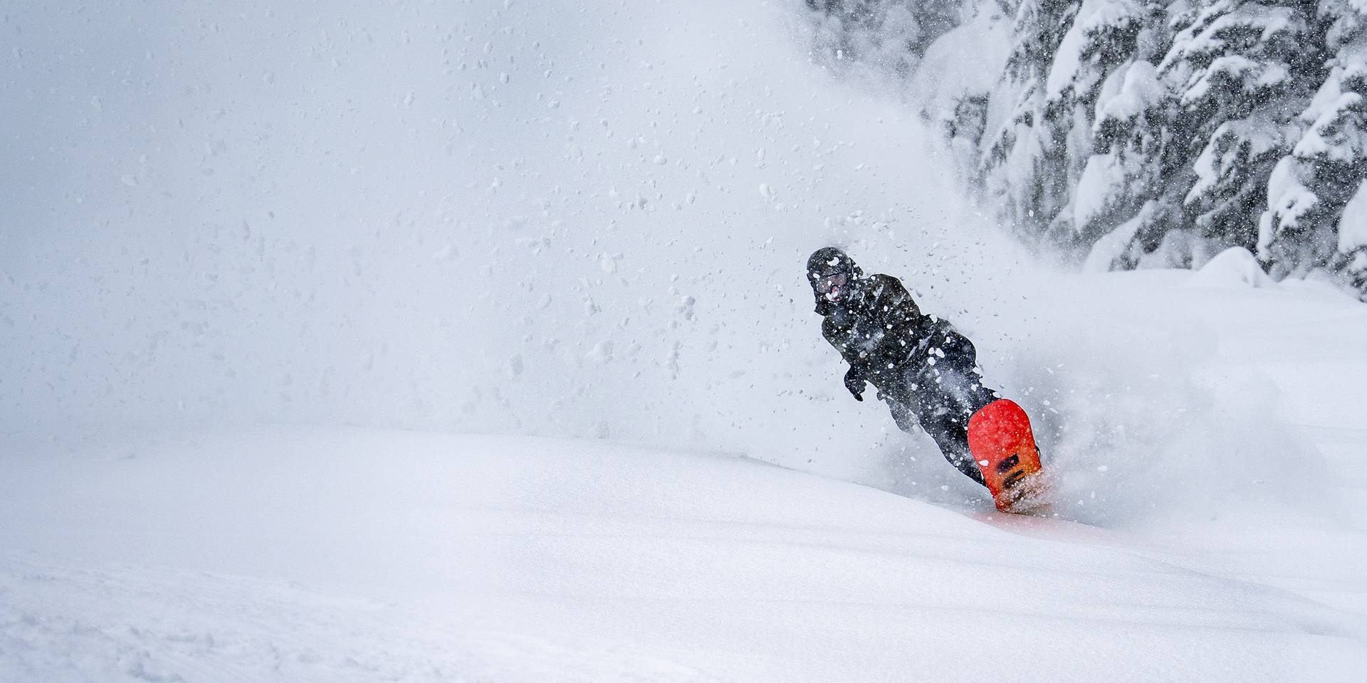 snowboarder wheely out of powder roost