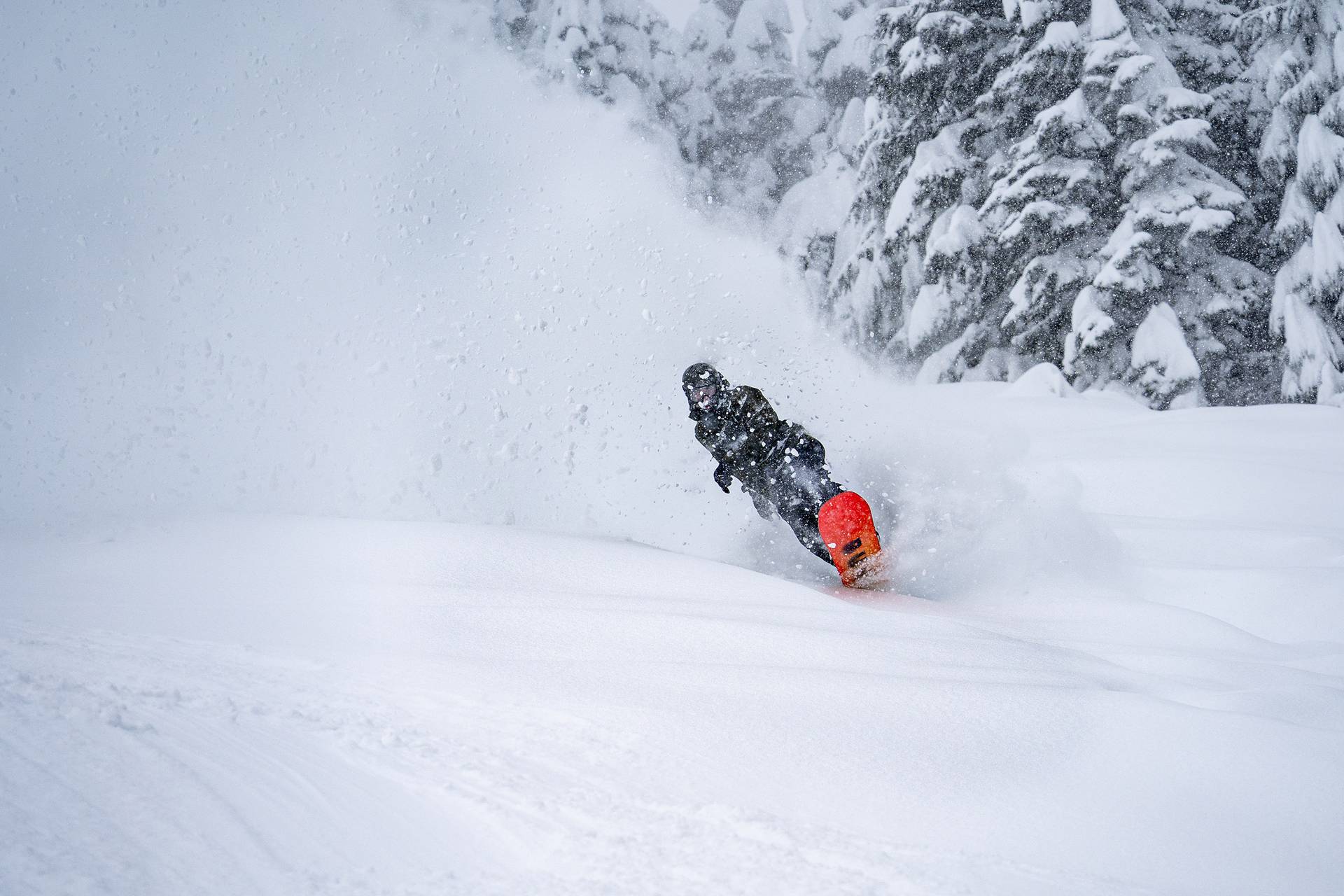 snowboarder wheely out of powder roost