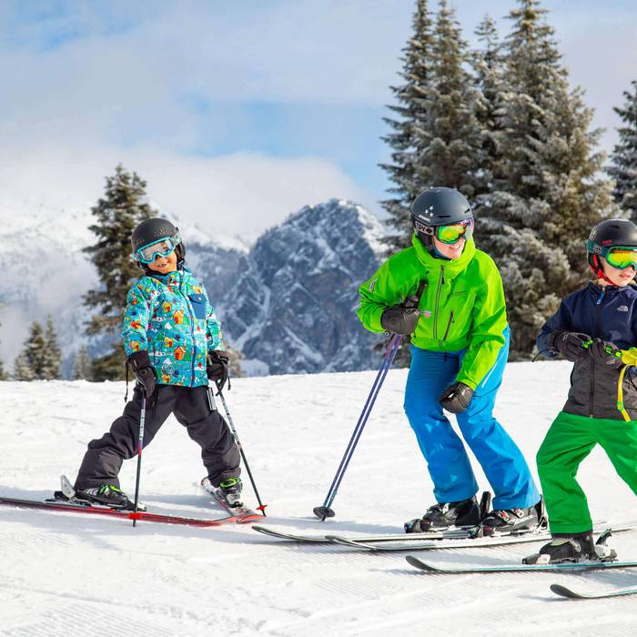 two students with ski instructor
