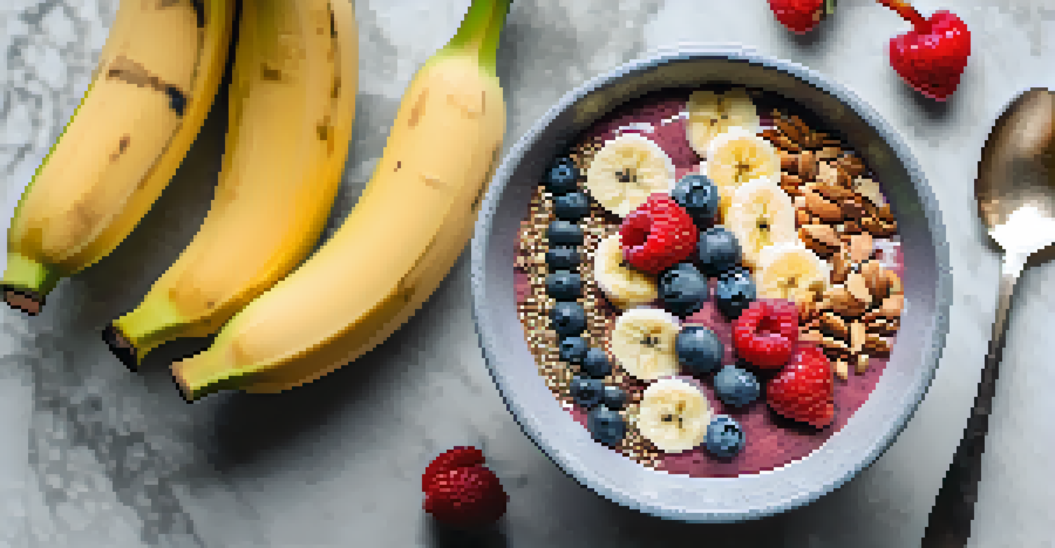 A close-up view of a smoothie bowl topped with bananas, chia seeds, and berries, placed on a marble countertop with a spoon beside it.